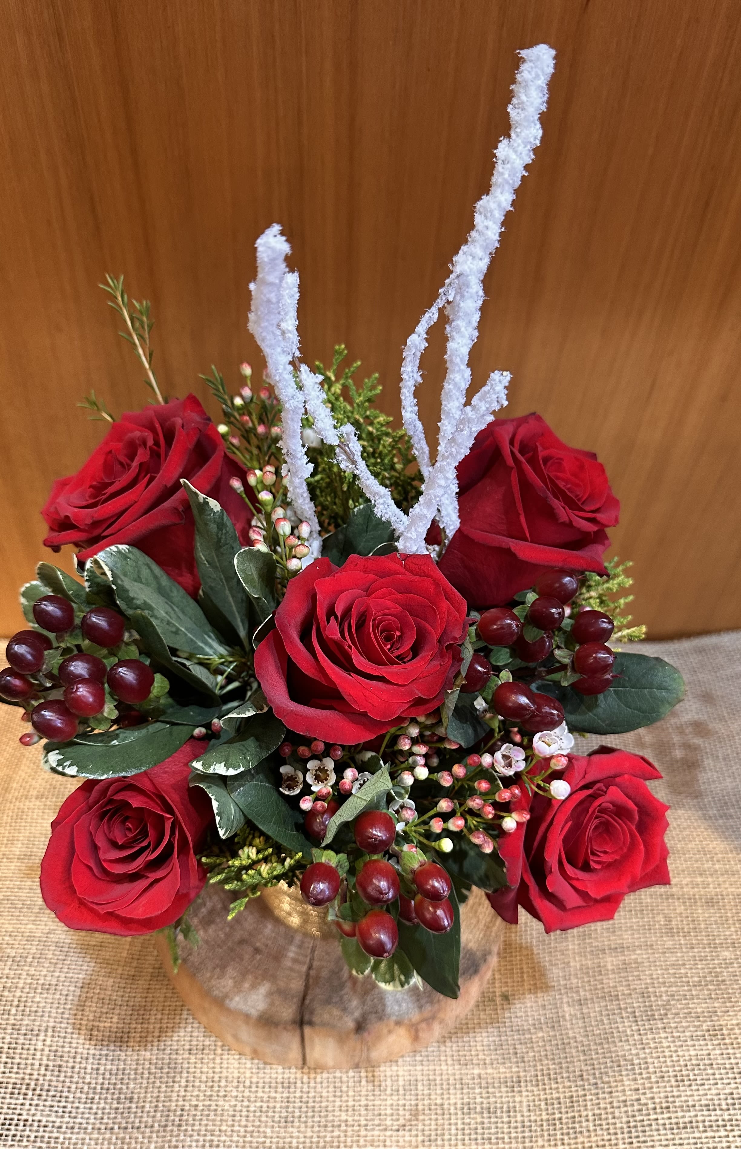 Secret Santa  - Premium quality red rose arrangement with Christmas season greenery. Arranged in a gold ceramic pot. 