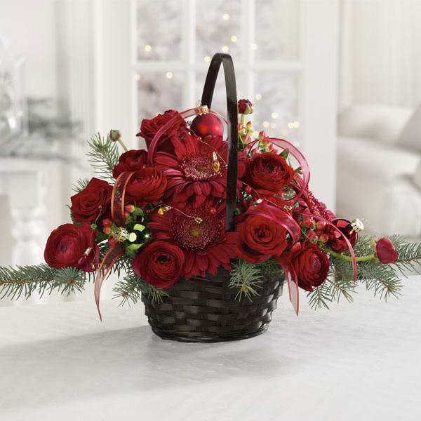Very Merry Red Basket - Fresh and fragrant Christmas greens create a fragrant base for the rich red roses, gerbera daisy, and ranunculus in our merry red centerpiece