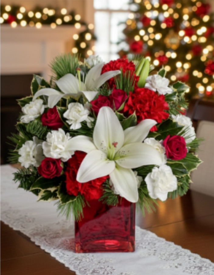 Caroling In The Snow by Teleflora - This festive holiday bouquet includes red roses and white asiatic lilies presented in our red mirrored cube.
