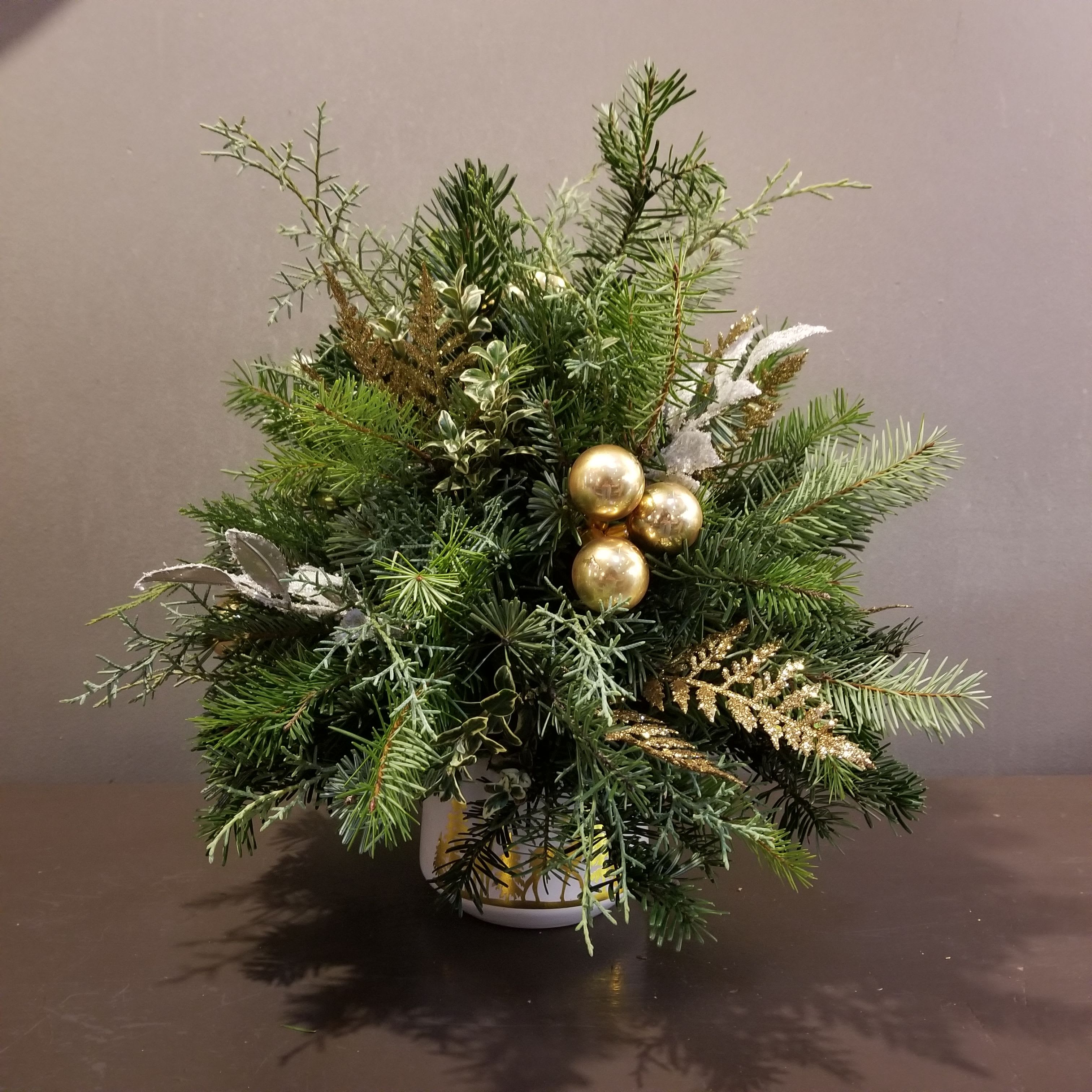 Tabletop Evergreen Trees - Doe a Deer - Small - Celebrate the season with this assortment of evergreens created for your table!  Adorned with gold accents, this tree measures approx. 16&quot; tall by 14&quot; wide.  Keep it watered and it will last the season!