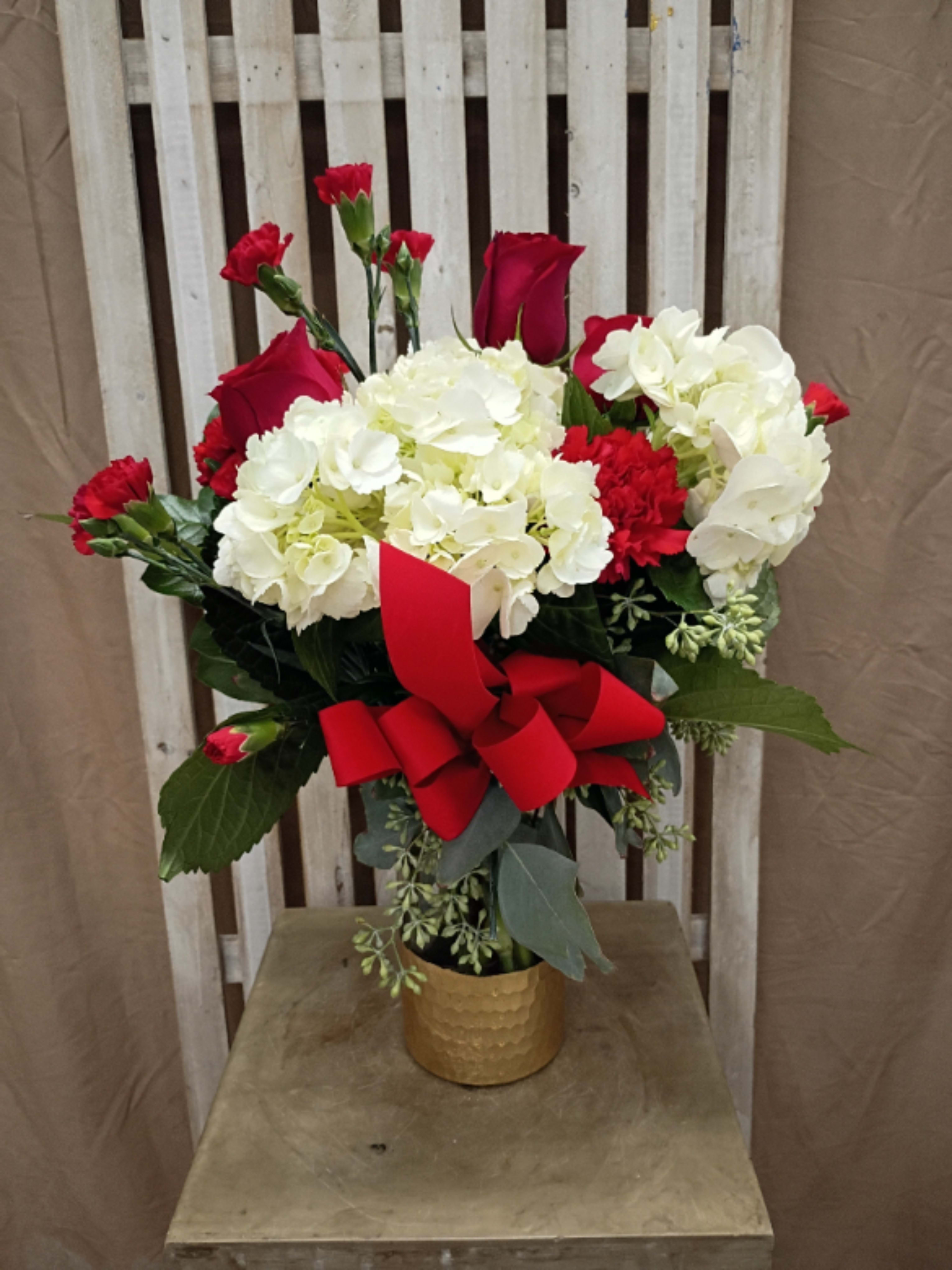 Christmas Joy - Spread some Christmas Joy with this beautiful arrangement of Roses, Carnations and Hydrangeas.  It is sure to brighten up someone's day.