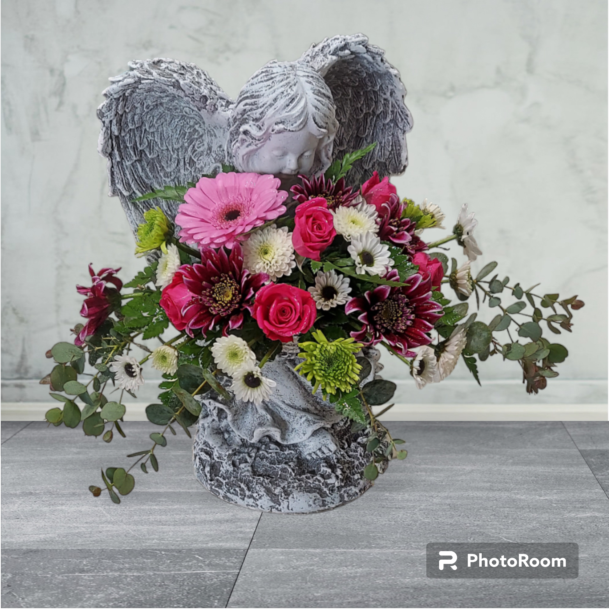 The Littlest Angel - The Littlest Angel is a concrete statue fit for indoor or outdoor use. A beautiful garden mix of flowers is displayed in her bowl. COLOR OF ANGEL AND FLOWERS WILL VARY WITH AVAILABILITY. ANGEL WILL EITHER BE GRAY OR TAN. Approximate size: 12.5&quot;H x 9&quot;W