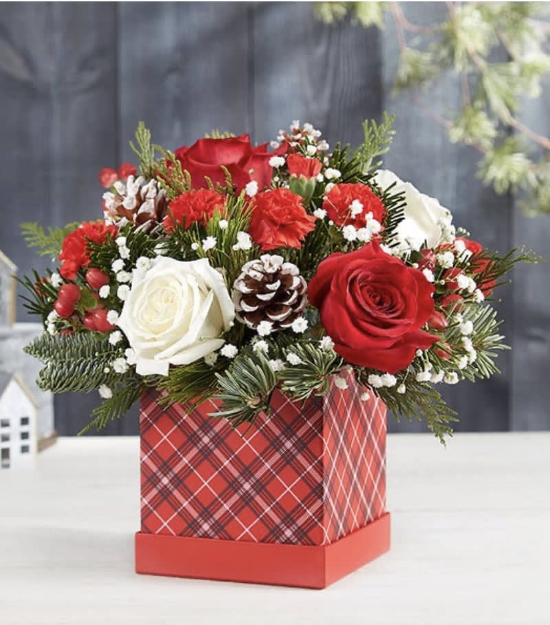 Christmas traditions  - Share Christmas traditions, while creating treasured new memories. Our classic holiday arrangement is designed in the season’s signature colors, with charming berries, snowy-tipped pinecones and fragrant greenery to add a warm, rustic touch. We’ve gathered it into our festive new plaid hat box, creating a joyful gift to bring us closer to the people we care about.