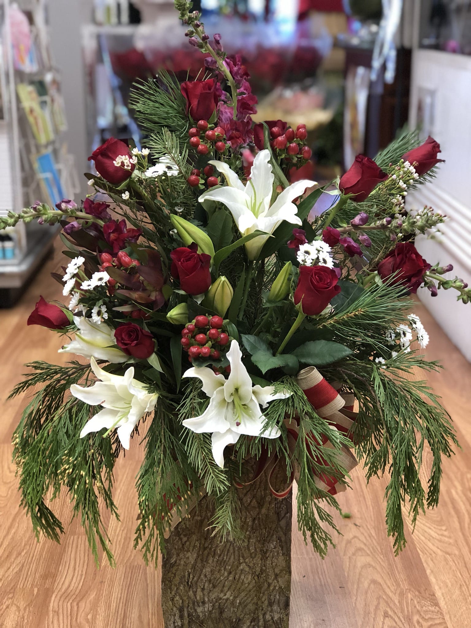 Roses,Lilies, with a x-mas twist  - This elegant rose and lilies mix is bound to bring cheer and joy to the household.