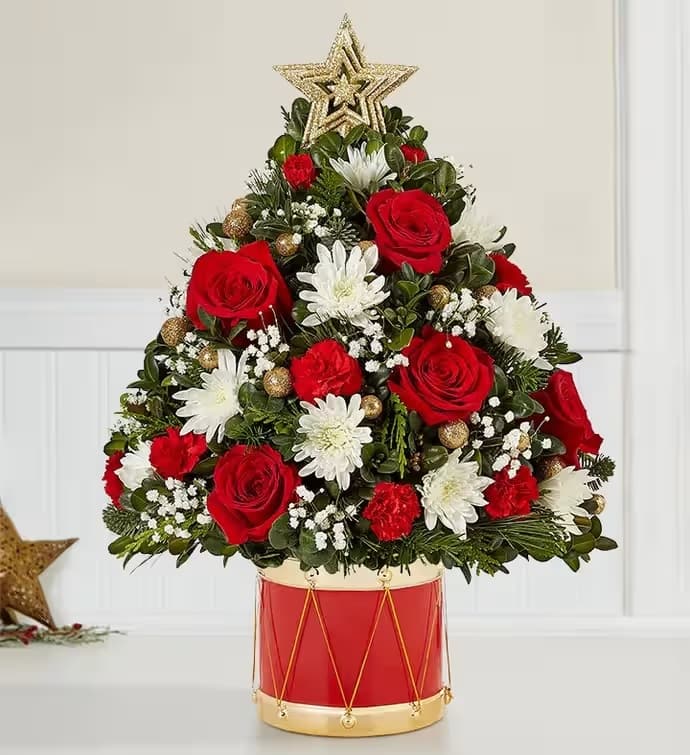 Holiday Drum Christmas Tree - The joy of gift-giving comes alive in the latest edition of our iconic Holiday Flower Tree. We’ve trimmed it with festive blooms, glittery gold ornaments and a star on top. Adding to the fun is our exclusive Musical Merriment drum container, inspired by the Nutcracker. Full of vintage charm, it’s a gift that delivers the magic of the season.