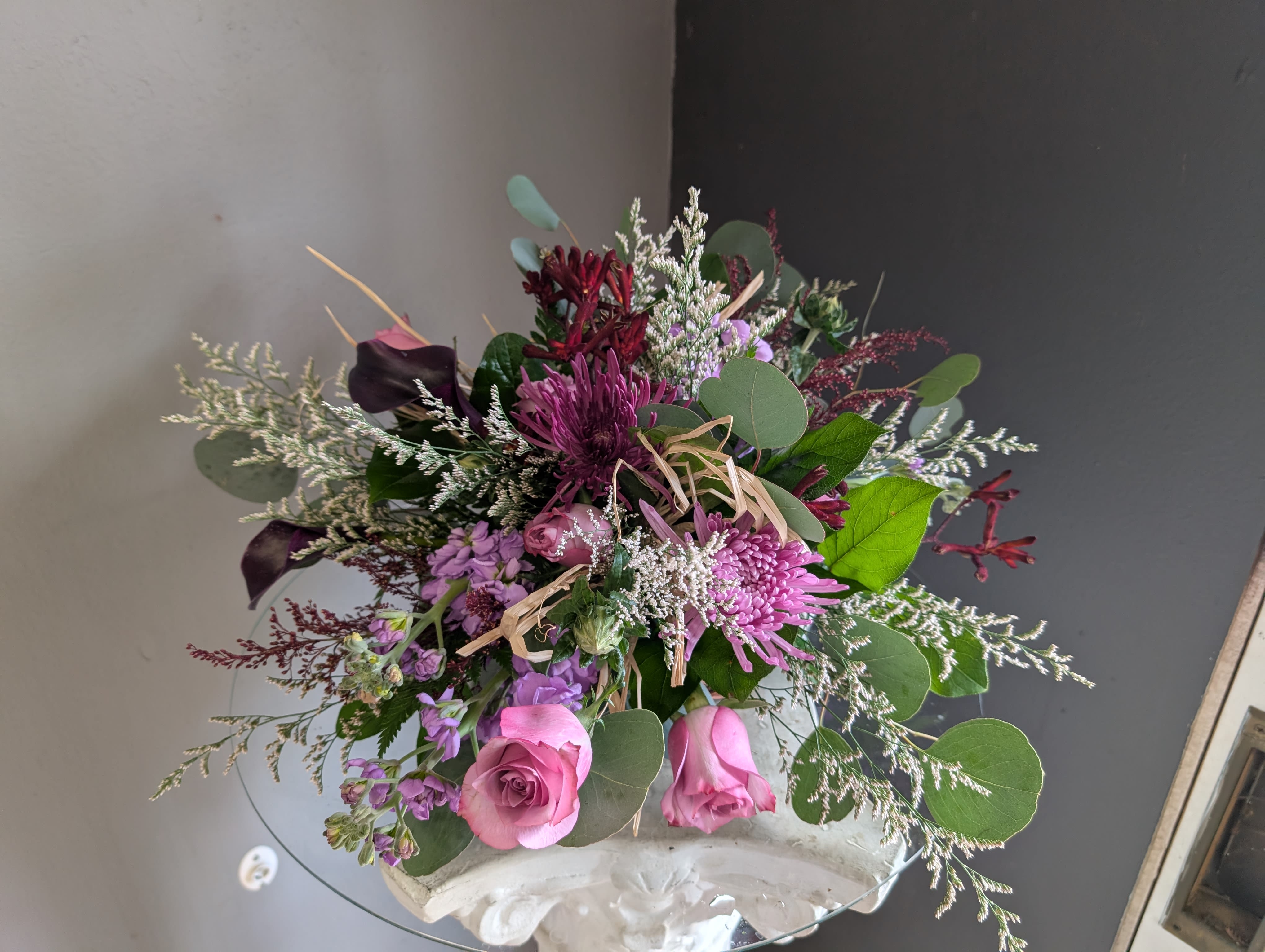 Holiday Centerpiece Table of 6 B - Beautiful arrangement of fresh flowers displayed inside a cornocopia 