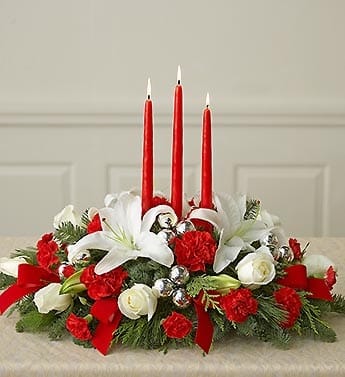 Christmas Noel Centerpiece - Fresh green ,red candles, white lilies, roses and miniature carnations accented with silver christmas balls