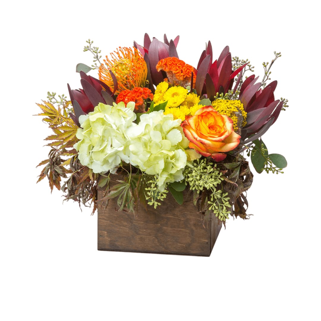 Happiness - This arrangement likes two things: being inside of a box and delivering happiness in the form of fall flowers. This would make a great centerpiece or an everyday pick me up before the snow flies. Do this arrangement a favor and let it deliver happiness to someone. Order one today! Would be great as a table centerpiece.  