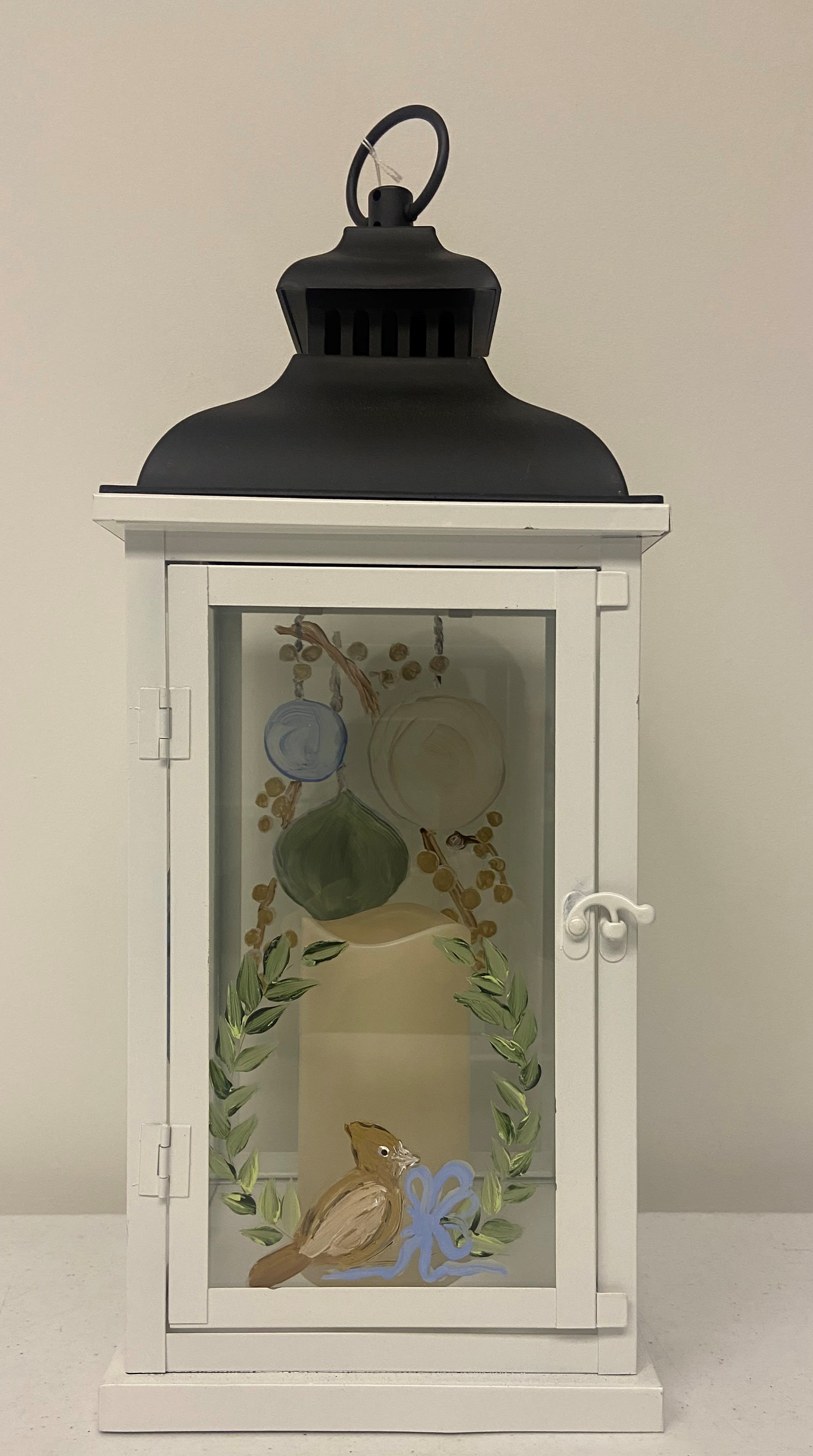 "Heaven &amp; Nature Sing" Lantern or Lantern Arrangement - A beautiful holiday themed local artisan hand-painted white metal lantern featuring muted soft toned Christmas bulbs and berries as well as a cardinal on the front panel.  Item includes an internal 6 inch battery operated candle as well as batteries.  Lantern measures 20 inches H x 7.5 inches W x 7.5 inches D.  