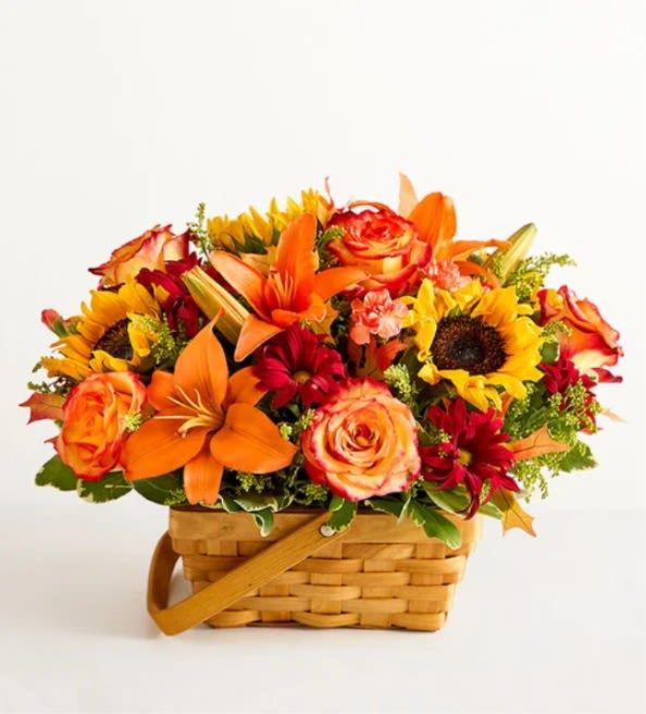 Fields of Europe for Fall Basket - About Fields of Europe for Fall Basket Inspired by the beauty of the European countryside, our best-selling autumn bouquet is designed with fresh-picked flowers in a charming basket. Pops of rich red among golden yellow and warm orange hues create a vibrant gift that lets them know they’re on your mind.  All-around arrangement with sunflowers, bicolor orange roses, orange Asiatic lilies and mini carnations, and red daisy poms, accented with assorted greenery Artistically designed in a handled splitwood basket with liner; measures 7&quot;H Large arrangement measures approximately 14&quot;H x 16&quot;L Medium arrangement measures approximately 13&quot;H X 15&quot;L Small arrangement measures approximately 12&quot;H x 14&quot;L Our florists hand-design each arrangement, so colors, varieties, and container may vary due to local availability To ensure lasting beauty, Asiatic lilies may arrive in bud form and will fully bloom over the next few days Sunflowers may have light or dark centers, based on local availability 