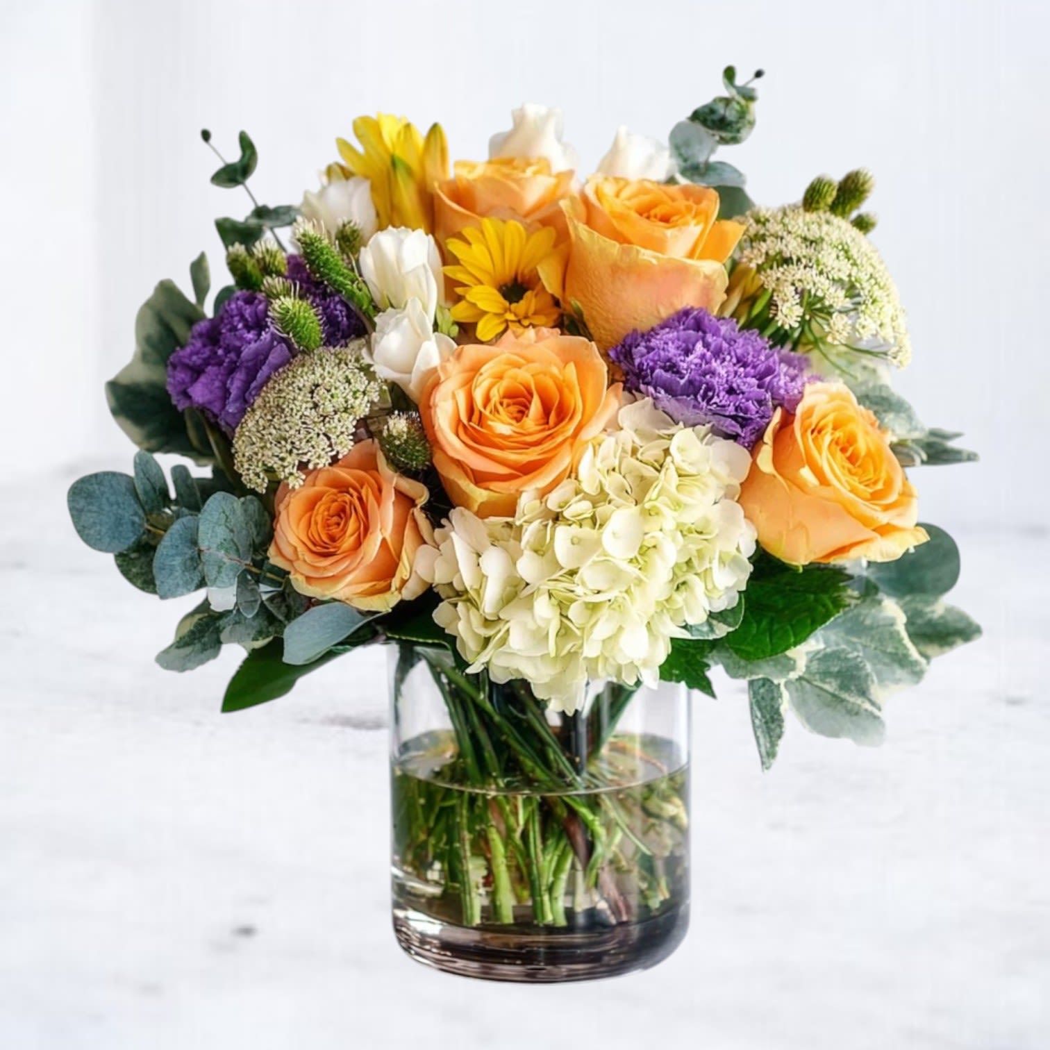 Jubilant Petals -  Bright &amp; Cheerful Birthday Flowers  Bursting with color and energy, Jubilant Petals is the perfect floral arrangement to make any birthday celebration extra special. This lively bouquet features golden yellow roses, lush green hydrangeas, purple and lavender stock creating a joyful and dynamic display. Accented with fresh greenery and delicate filler blooms, this bouquet embodies happiness and warmth.  Ideal for birthday surprises, get-well wishes, or sending a cheerful &quot;just because&quot; gift, Jubilant Petals is a stunning floral statement that brings smiles and positivity. Available for same-day delivery in Houston and surrounding areas, ensuring your thoughtful gift arrives fresh and full of life.