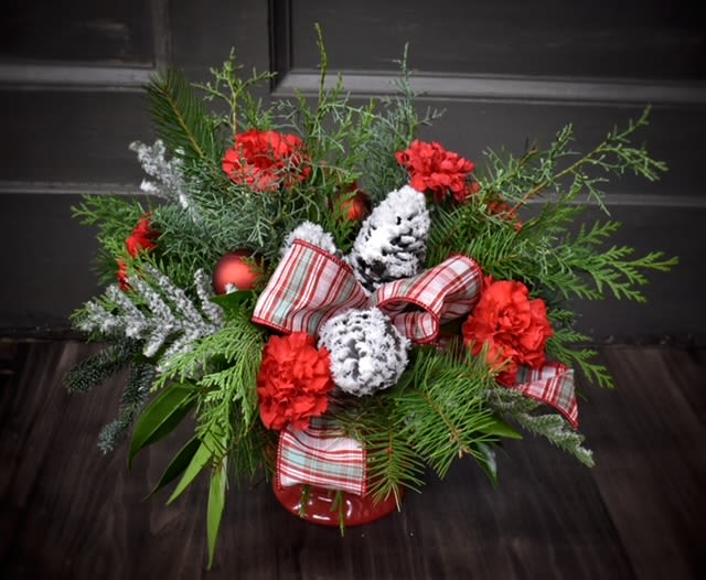 Peppermint Delight - Available for Local St. Cloud, MN Delivery Only - A Peppermint gift sure to delight your loved ones! Winter greenery and carnations in a Christmas red keepsake container.