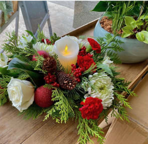 O' Holy Night - Table centerpiece incorporating white artificial candle with real looking flame, fresh cut flowers and Christmas greens