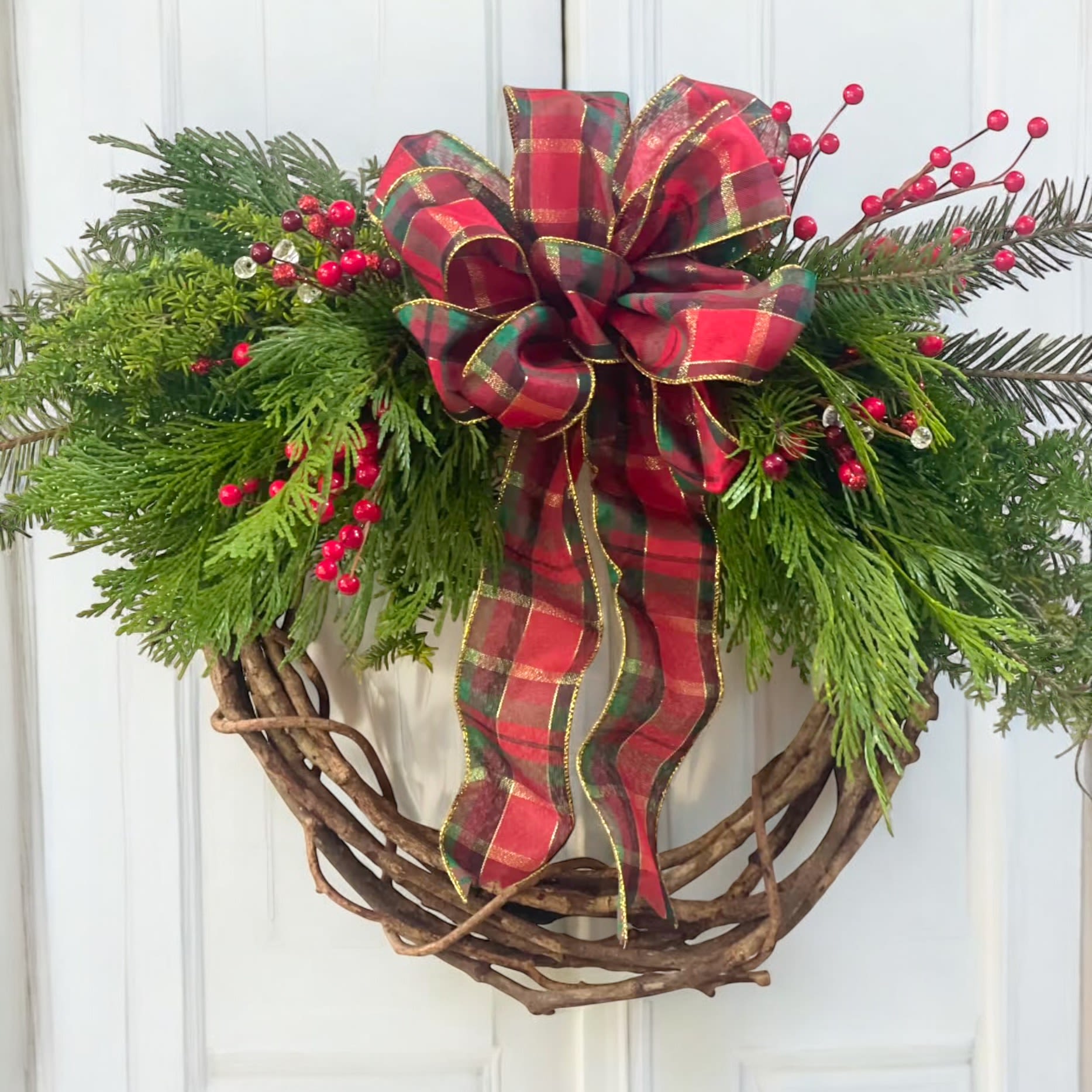 Extra Large Farmhouse Wreath  - Hand crafted willow wreath with locally grown evergreens. Decorated with a center bow.  *Print on bow can vary from the one pictured. 