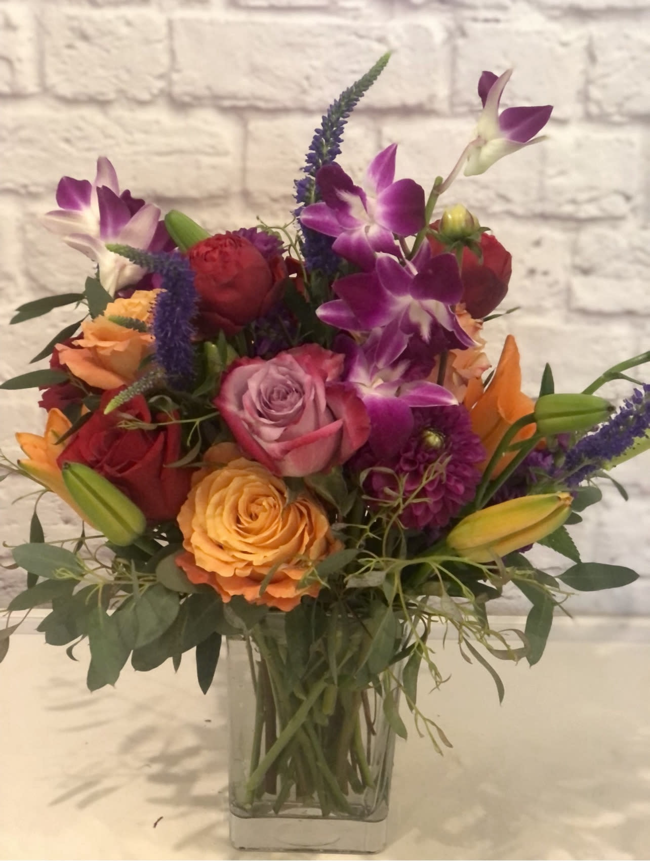 Wild Berries  - Tulips, roses, oriental lilies, and ranunculus in berry hues in a square cube.  Perfect flowers for birthdays, &quot;get well soon,&quot; congratulations, romantic gestures, and &quot;Thank you.&quot; Also a beautiful wedding palette.  Available for delivery in Seattle, Bellevue, Shoreline, and surrounding areas. Available for delivery in all neighborhoods in Seattle including Magnolia, Ballard, Fremont, Downtown, Queen Anne, Crown Hill, U District, West Seattle, International District, Capitol Hill, Pioneer Square, Beacon Hill, Columbia City, Georgetown, etc.  