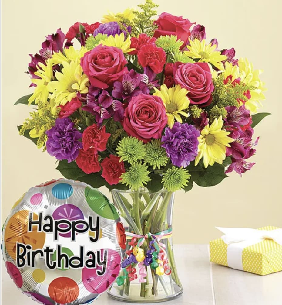 It's Your Day Bouquet® Happy Birthday - Get their birthday party started with a big bunch of smiles! Our bright &amp; colorful bouquet of fresh carnations, daisy poms and more—complete with a festive “Happy Birthday” balloon—lets them know it's their day to shine.  Our florists hand-design each arrangement, so colors, varieties and container may vary due to local availability Hand-crafted arrangement of hot pink roses, purple carnations, hot pink mini carnations, yellow daisy poms, purple alstroemeria, athos poms, solidago and salal Gathered in a stylish glass vase tied with colorful ribbon; vase measures 8"H x 4"D Arrives with an 18"D Mylar "Happy Birthday" balloon; design on balloon will vary due to local availability Large arrangement measures approximately 16"H x 13"W Medium arrangement measures approximately 15"H x 11.5"W Small arrangement measures approximately 14"H x 10"W