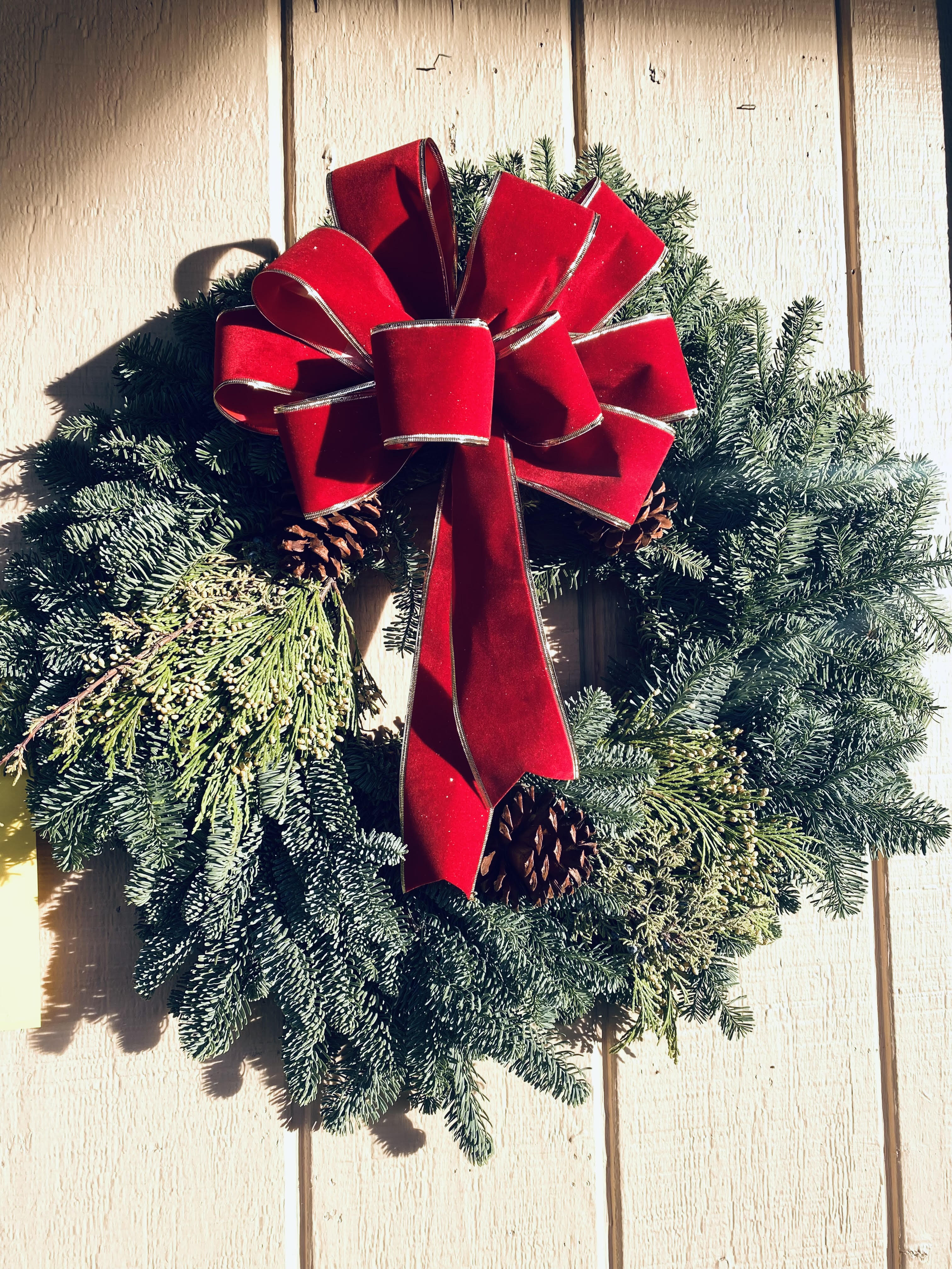 The Christmas Traditions Wreath - A 20&quot; Fresh mixed pine wreath crafted with a Red Bow &amp; Pinecones.  (Bow may vary, but will be red in color) Say Happy Holidays from afar, with our Christmas Traditions wreath and deliver the smell and spirit of the holidays!