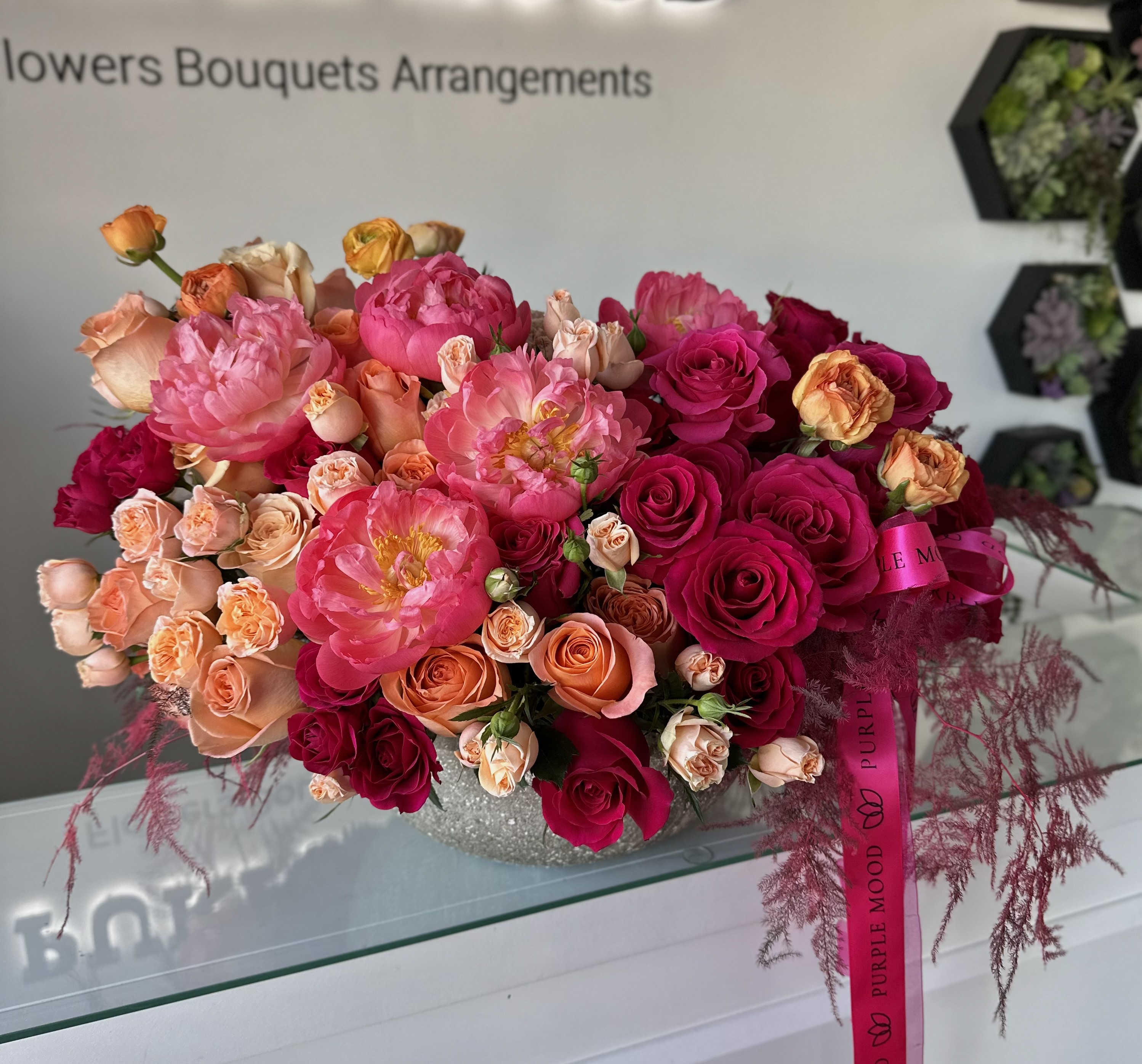 Trendy Vase - Large Trendy Vase Bold, vibrant, and unforgettable — the Trendy Vase is a true statement piece. Overflowing with rich pinks, fiery reds, and warm orange tones, this arrangement brings luxury and energy into any space. Perfect for grand celebrations, luxury gifting, or simply making a stylish impression.      •    Striking combination of bold, trendy colors     •    Arranged in an elegant modern vase     •    A large, luxurious design that captures attention instantly     •    Ideal for upscale events, anniversaries, or luxury gifts