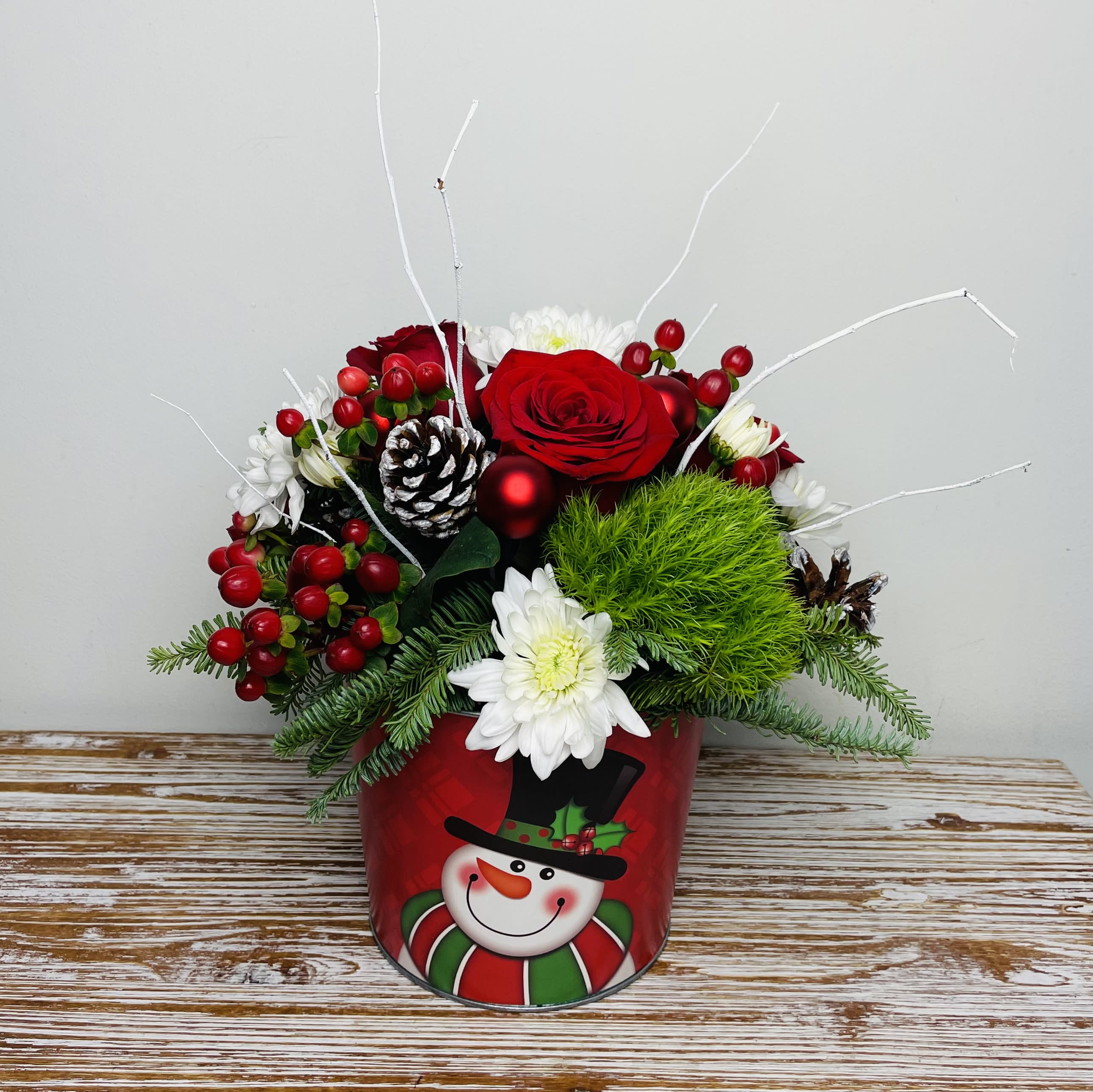 Frosty - Frosty the Snowman was a jolly happy soul and his legend lives on in our Frosty arrangement. Perfect for the Holiday Season!  Approximately 16” Tall