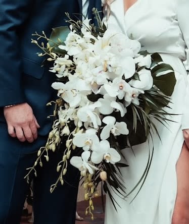 The Altman Bouquet - This bridal bouquet consists of all white flowers including lilies, stock, roses, spray roses, veronica, dendros, phalaenopsis with italian ruscus and eucalyptus. BB100