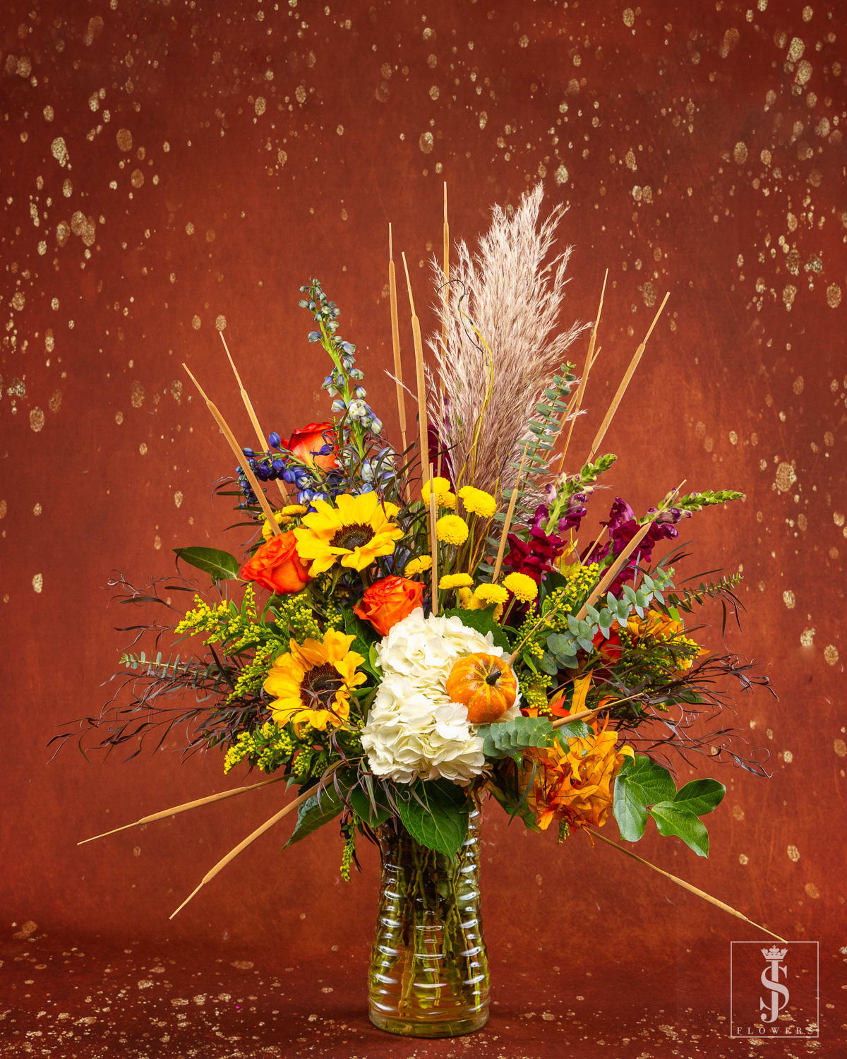 Pumpkin Spice (Designers Choice Tall Mix) - Looking for something sweet? Bite into our Pumpkin Spice Arrangement ! It's a colorful combination of farm-fresh roses, orchids sunflowers, and beautiful daisy palms surrounded with green accent flowers. One of our most versatile fall arrangements., this pretty mix is meant for all types of occasions and recipients!