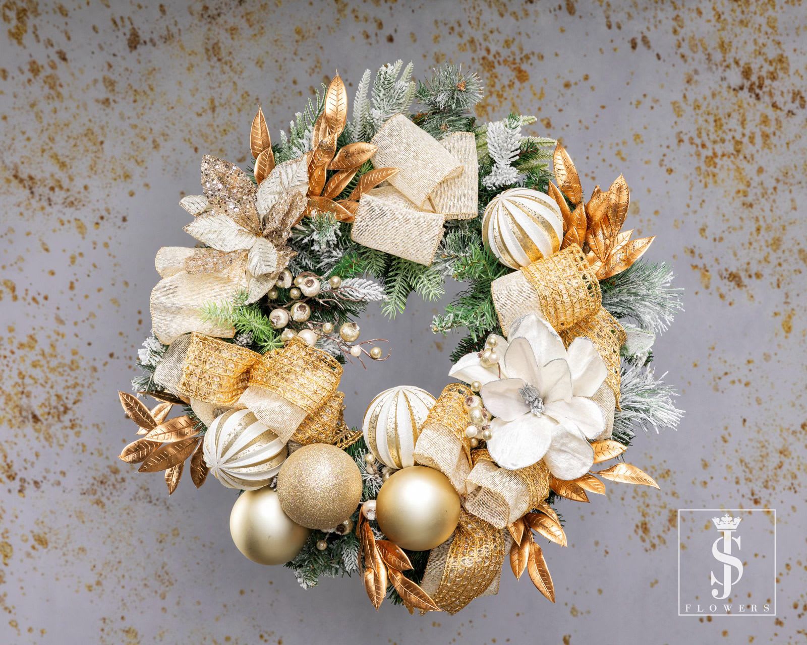 Radiant Gold Wreath - The Radiant Gold Wreath is the perfect blend of elegance and festive charm. Featuring luxurious metallic gold leaves, frosted greenery, and shimmering golden ornaments, this wreath adds a touch of sophistication to your holiday décor. Delicate floral accents and glittering bows create a captivating centerpiece that exudes warmth and joy. Handcrafted with care, it’s designed to bring timeless beauty to your home. Perfect for doors, walls, or mantels, this wreath is a celebration of the holiday season’s golden glow. Transform your space into a winter wonderland with this stunning masterpiece!