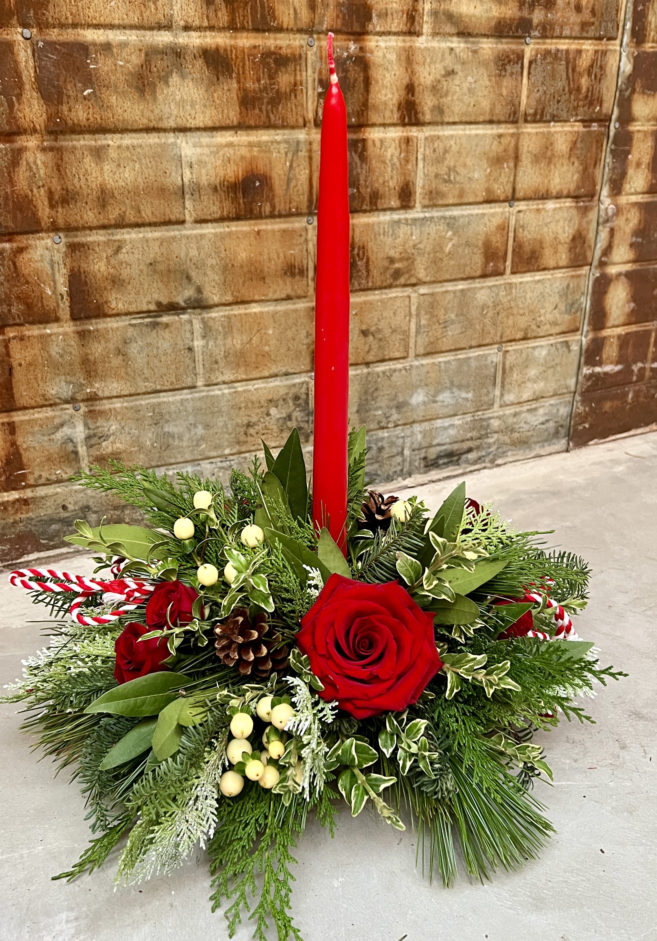 Let's Celebrate! | The Single - Single candle centerpiece with a mixture of fresh wintergreens, roses and accents.  Deluxe: Add more flowers and accents