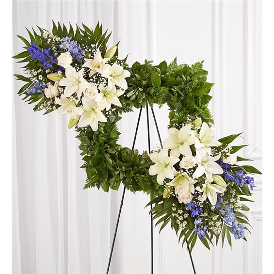 Cherished Remembrance™ Wreath - Blue &amp; White - Celebrate the cherished memories you shared with a beautiful floral arrangement. Our unique design features a square wreath of greenery—perfect for displaying a photo—and two sprays on each end gathered with soothing blue &amp; white blooms for a lush, full presentation. It’s a special tribute to honor the life of a loved one. (Picture not included)