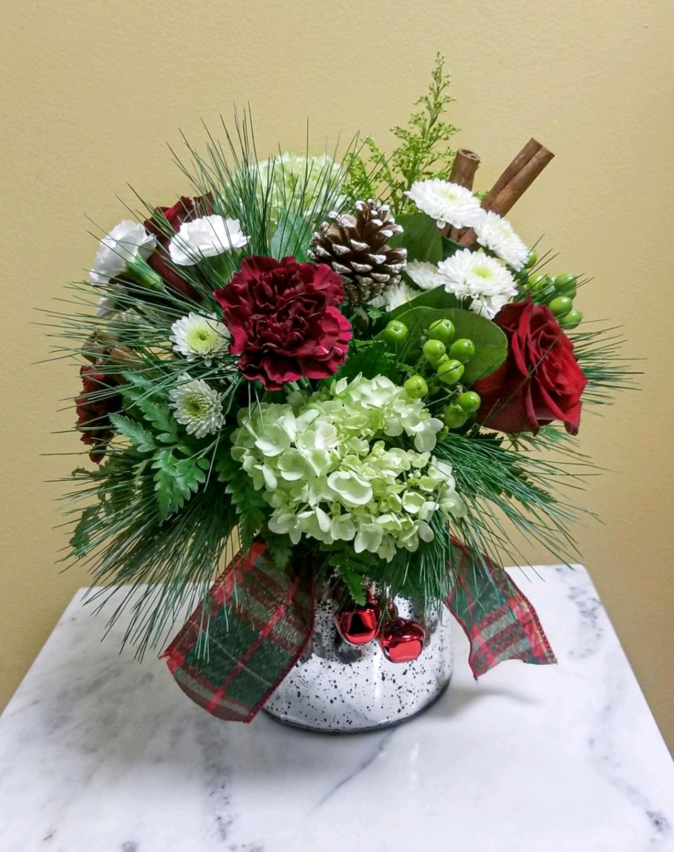 Jingle Jangle - A holiday mercury vase adorned with jingle bells and ribbon filled with seasonal favorites.. 
