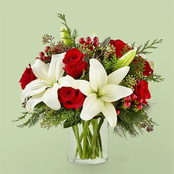 Glittering Lights Bouquet - Illuminate their day with the Glittering Lights Bouquet, a delightful mix of holiday greens and standout stems to bring the scents of the season indoors.  Details Designed by florists, ready to display. For long–lasting blooms, replace the water daily. We suggest trimming the stems every couple days. Pet Safety Precautions: This bouquet or plant may include flowers and foliage that are known to be toxic to pets. To keep them safe, be sure to keep this arrangement out of your pet's reach