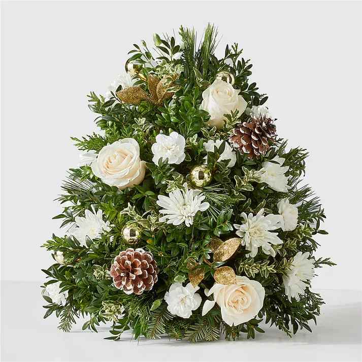 Snowed In Tree - No need to brave the cold this winter when you can bring the beauty of the outdoors in with our Snowed In Tree, a handcrafted mini tree featuring icy white blooms. This gift can make birthdays brighter, holidays more cheerful, and everything in between.  Details The Premium Bouquet is approximately 16"H x 14"W. Designed by florists, ready to display. For long–lasting blooms, add water daily. Pet Safety Precautions: This bouquet or plant may include flowers and foliage that are known to be toxic to pets. To keep them safe, be sure to keep this arrangement out of your pet's reach.