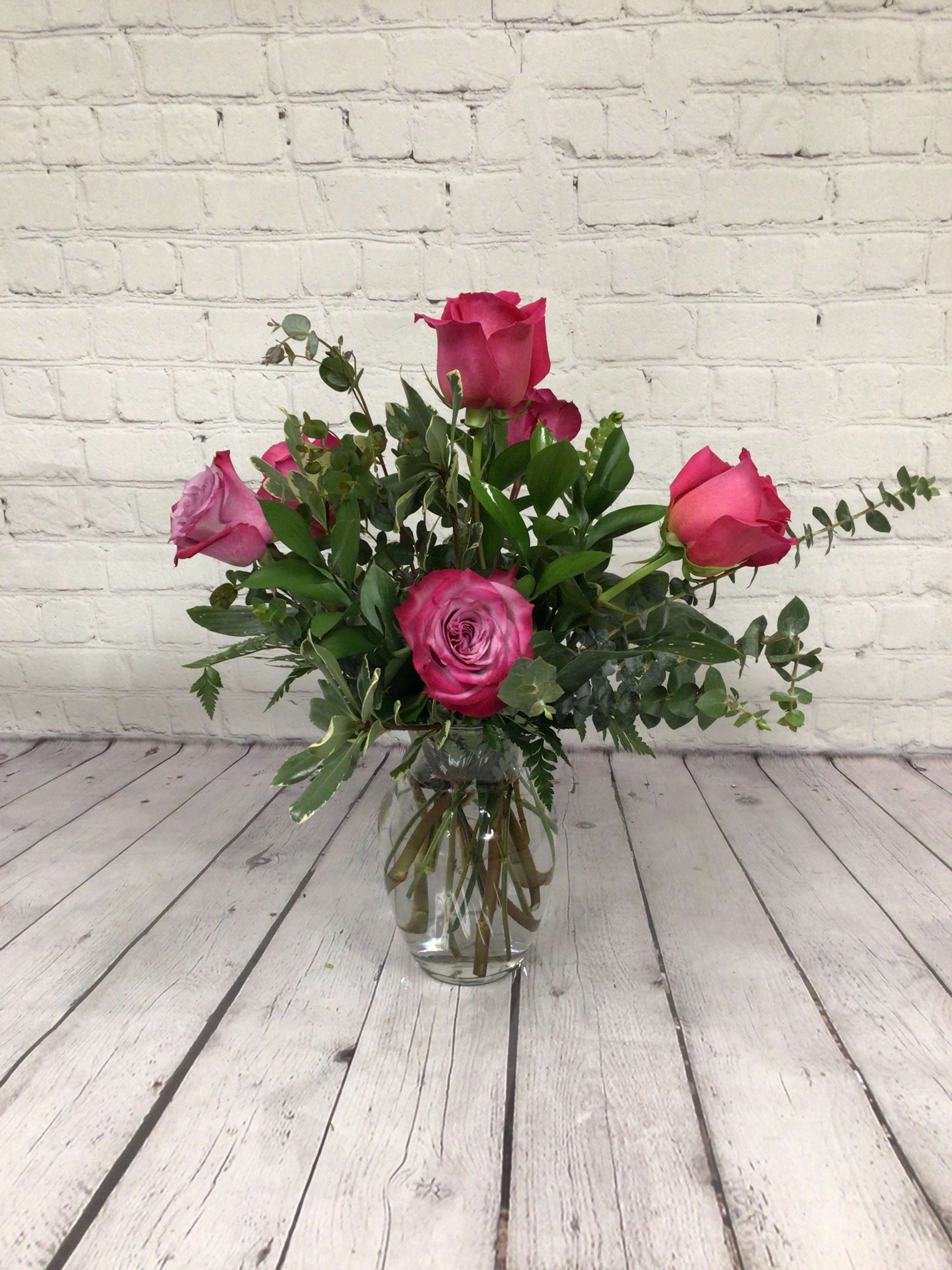 Half dozen lavender roses arranged - A half dozen lavender roses arranged in a vase with assorted greenery.