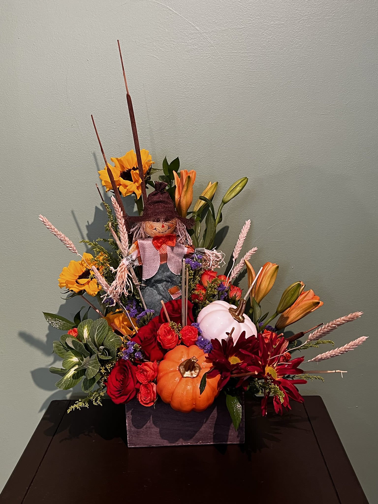 Festive Fall Creation  - This is an arrangement to show your love of fall and all that it entails. Decorative pumpkins, fall leaves, and various dried accents complete this arrangement.
