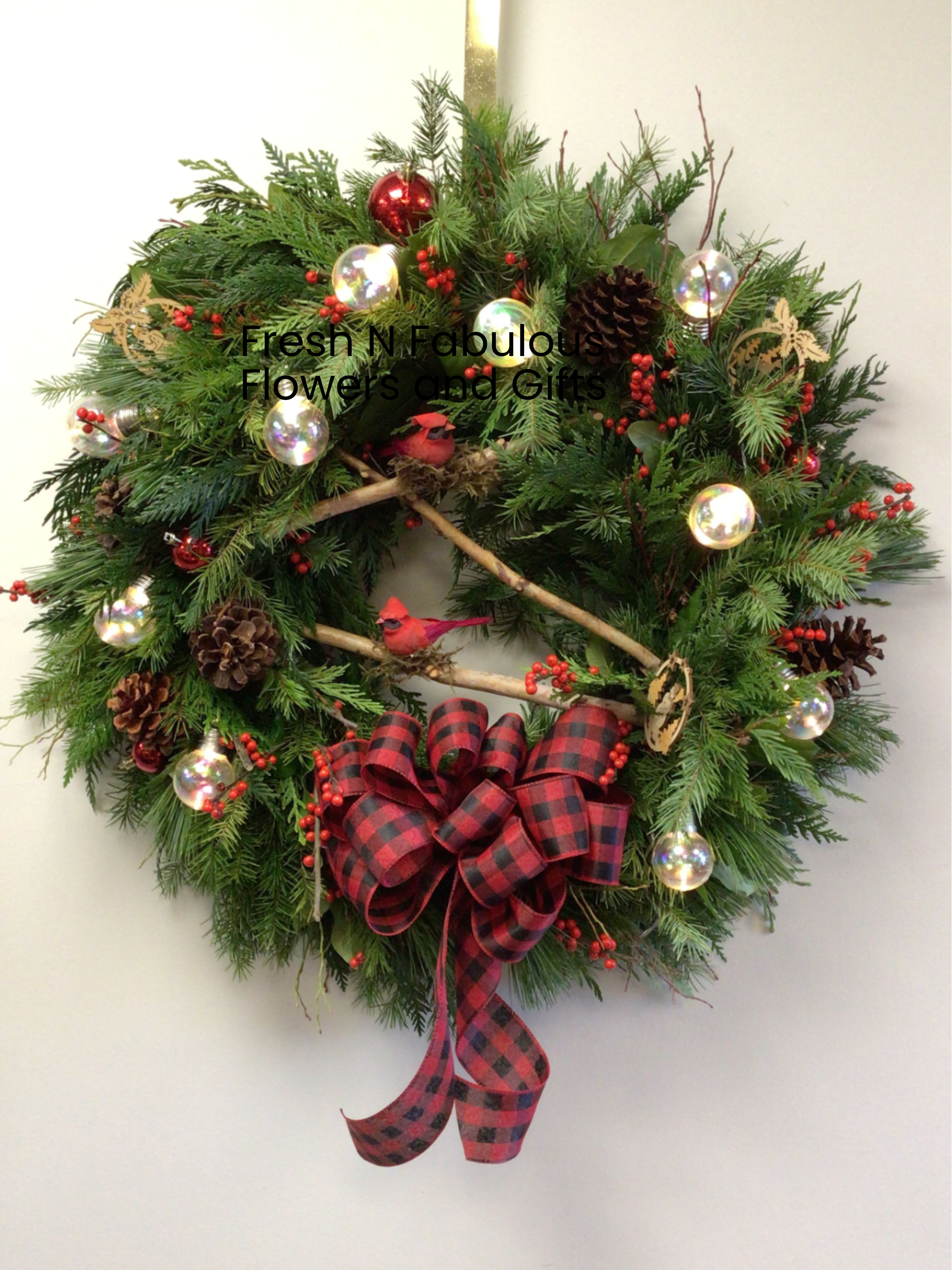 Birch and cardinal wreath -  All our Wreaths are hand made by our designers at Fresh N Fabulous Flowers, with the freshest local greenery that lasts all season, decorated for the Christmas season, making them a wonderful gift. This one includes cardinals and birch branches and lights up Approx. 22” round