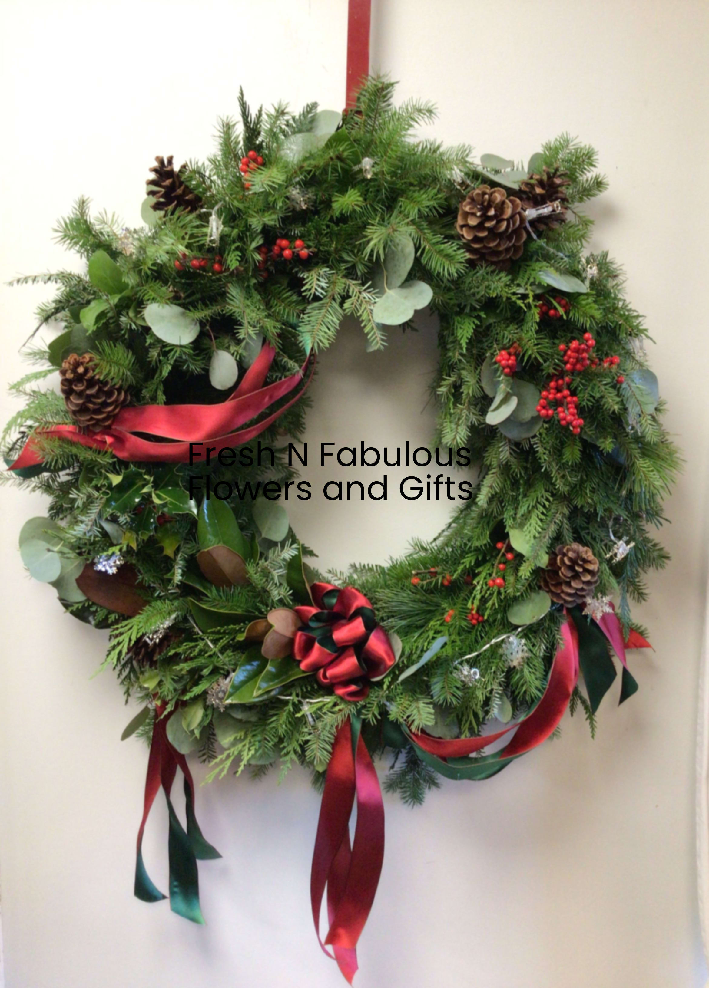 Lux Wreath - A 22 inch diameter luxurious fresh wreath ready for the festive season. Using a variety of local greens, berries and festively adorned with ribbon. Ready to hang to celebrate the season