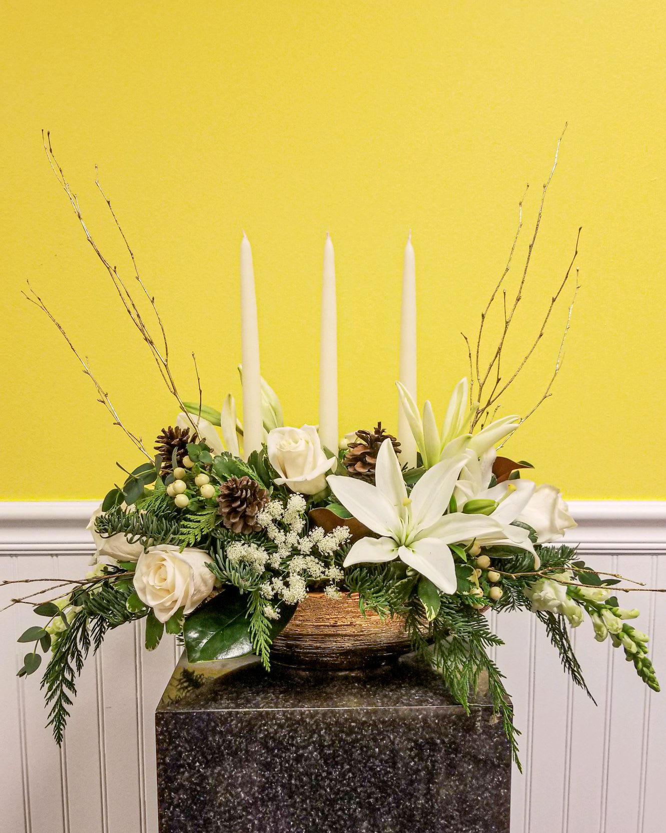 Star of Christmas Centerpiece - This centerpiece is a stunner !  The base is a 14 inch gold boat shaped ceramic bowl.  Includes 3 taper candles and filled with fresh wintergreens and adorned in white blooms.