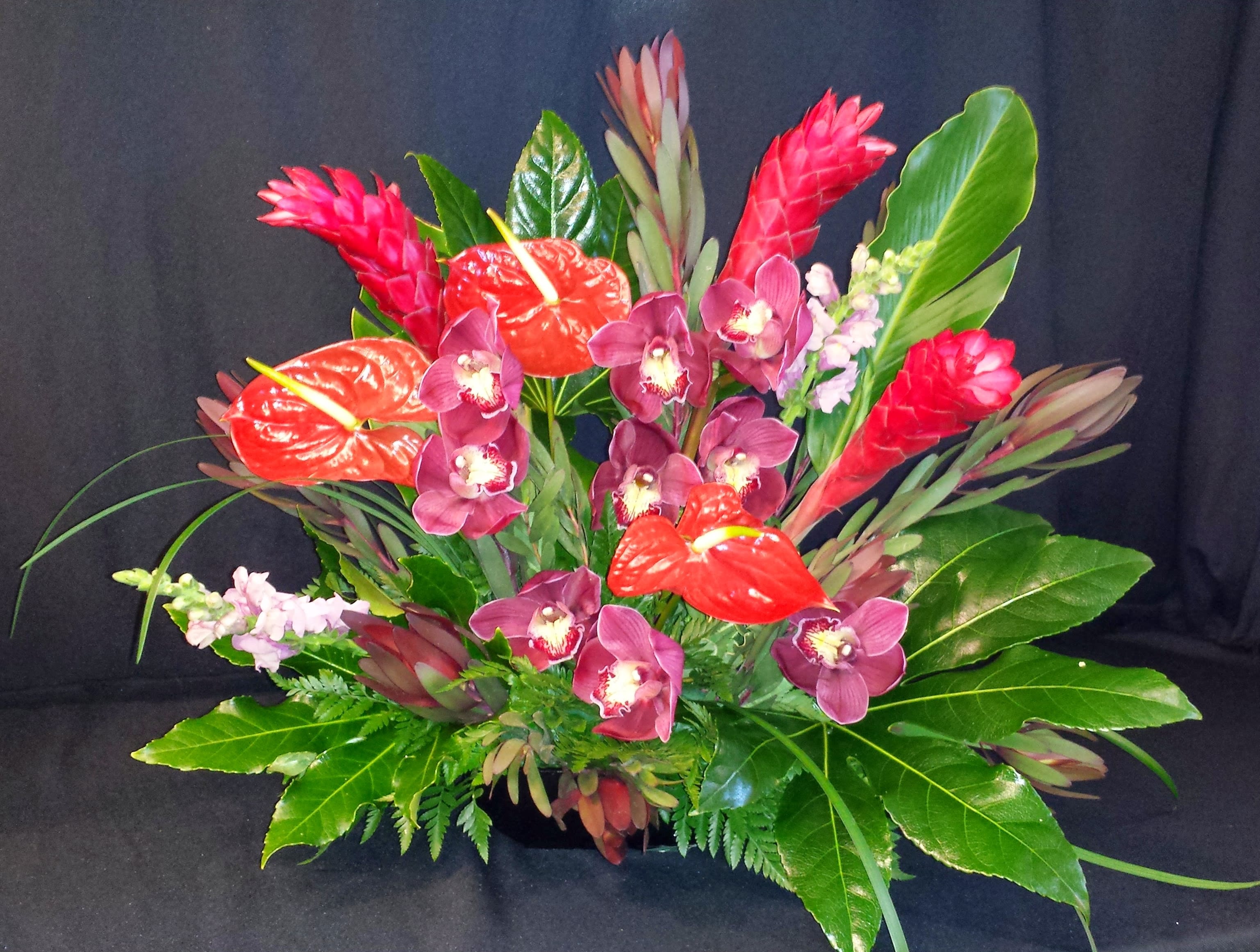 Tropical Triangle Bold and Bright, colors vary - Amazing display of flowers for a Grand opening or Event display. Wowza!   Flowers &amp; colors may vary. Order well in advance, especially within the weeks prior to Valentine's day. Colors can be customized, as with most of our arrangements, with an advance order.  Beautiful exotic bouquet for a grand gesture.  See various examples on Standard Pricing tab.