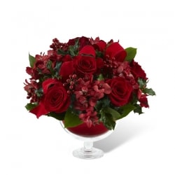 16-C9 Holiday Delights Bouquet - Alluring, elegant, and nothing short of stunning, this flower bouquet is ready to celebrate the Christmas season in unmatched style and grace. Rich red roses capture your attention with their swirling array of petals surrounded by burgundy carnations and mini carnations and accented with holly, lush Christmas greens, shining matte gold glass balls, and burgundy ribbon. 