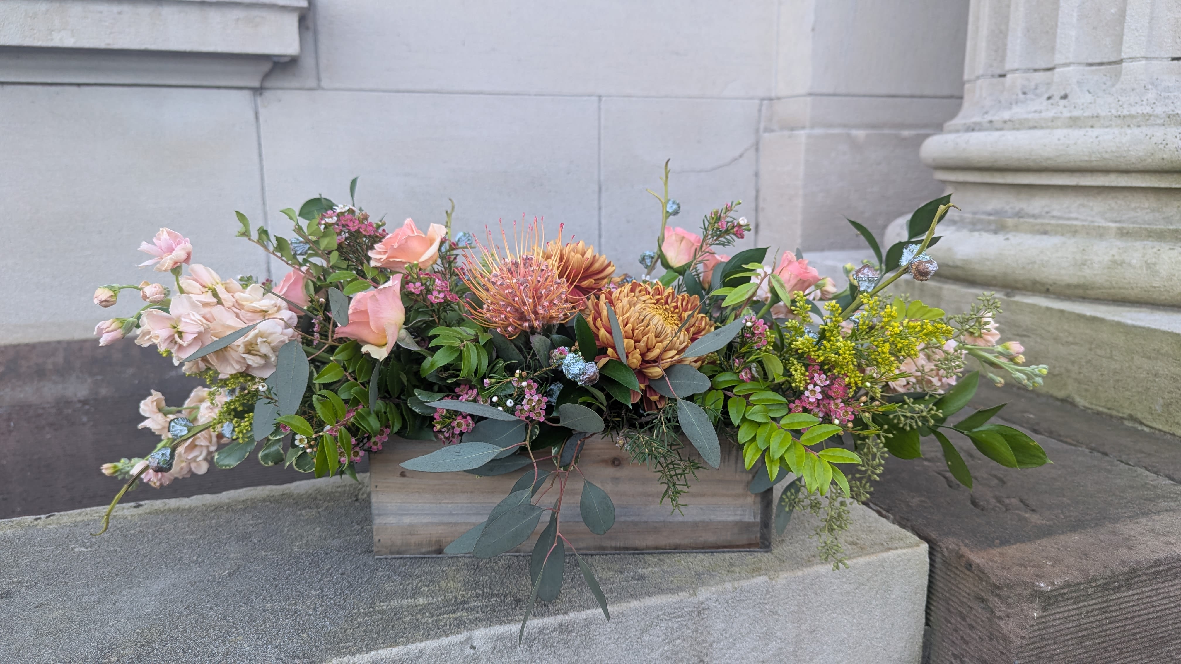 Autumn breeze - Long, low centerpiece suitable for a dinning table. Mixture of textures, unique blooms and traditional flowers.  