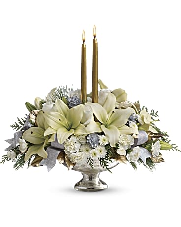 Teleflora's Silver And Gold Centerpiece - Celebrate the season with this majestic centerpiece of sparkling silver and glamorous gold. Bright white lilies and winter greens arranged in a shimmering mercury glass bowl will cast a lovely light on any holiday table.