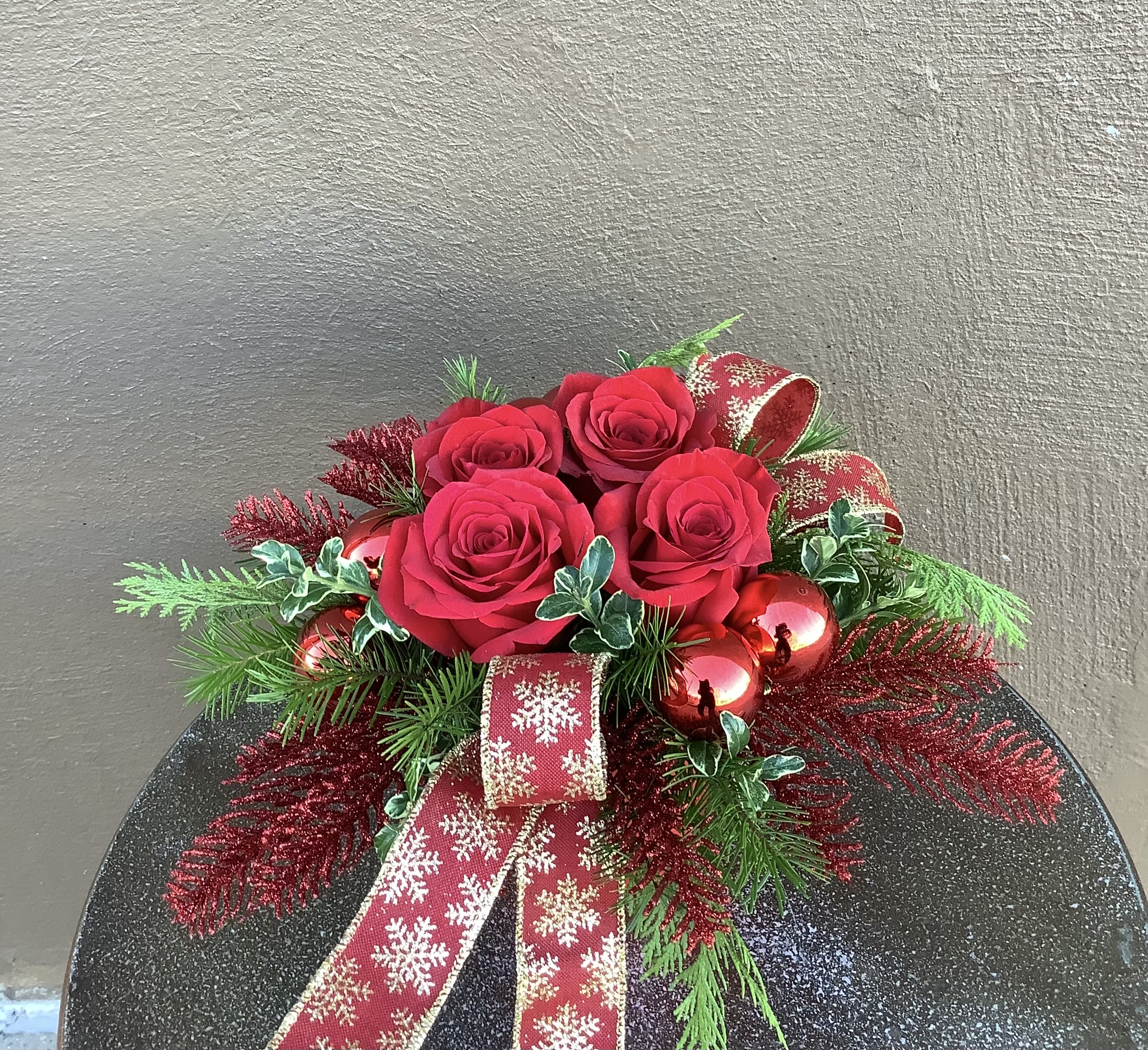 Festive Rose Garden - Stunning red roses surrounded by winter foliages and sparkly, gold accents all tied up as pretty as a package! A perfect way to celebrate the season.
