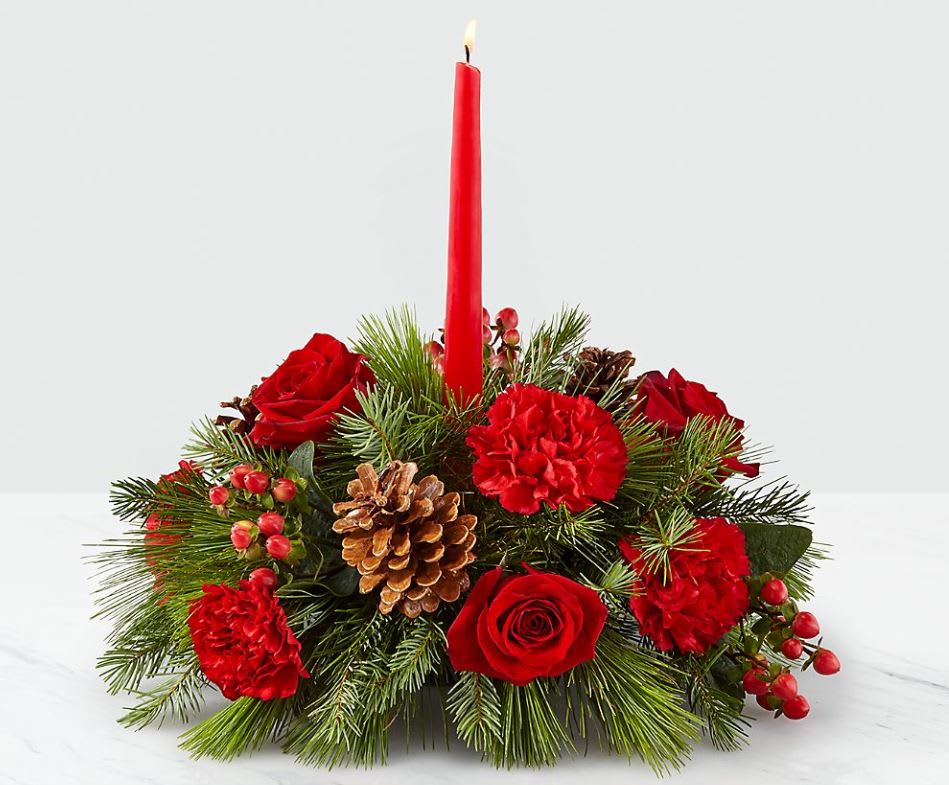 Round Christmas Centerpiece With Taper - Festive, &quot;Christmassy&quot; centerpiece will be made as similar as possible to the photo but you can count on mixed red flowers, evergreens and pinecones in a low profile dish and a red or burgundy taper candle. Price shown in photo is $65.