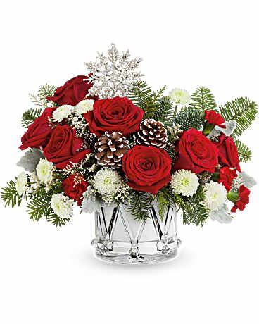 Teleflora's Little Drummer Joy Bouquet - Teleflora's Little Drummer Joy Bouquet marches in the holiday cheer with red roses, wintery greens, and festive white blooms in Teleflora's keepsake Crystal Drum Vase. A joyful gift for any Christmas celebration. Teleflora's Little Drummer Joy Bouquet includes red roses, red miniature carnations, white button spray chrysanthemums, and white limonium. Accented with cedar, dusty miller, and noble fir in Teleflora's Crystal Drum Vase Orientation: All-Around  SUBSTITUTION POLICY – Always deliver the freshest flowers! Please note the bouquet pictured reflects our original design.  If the exact flowers or container in this arrangement are not available, our local florists will create a beautiful bouquet with the freshest available flowers.