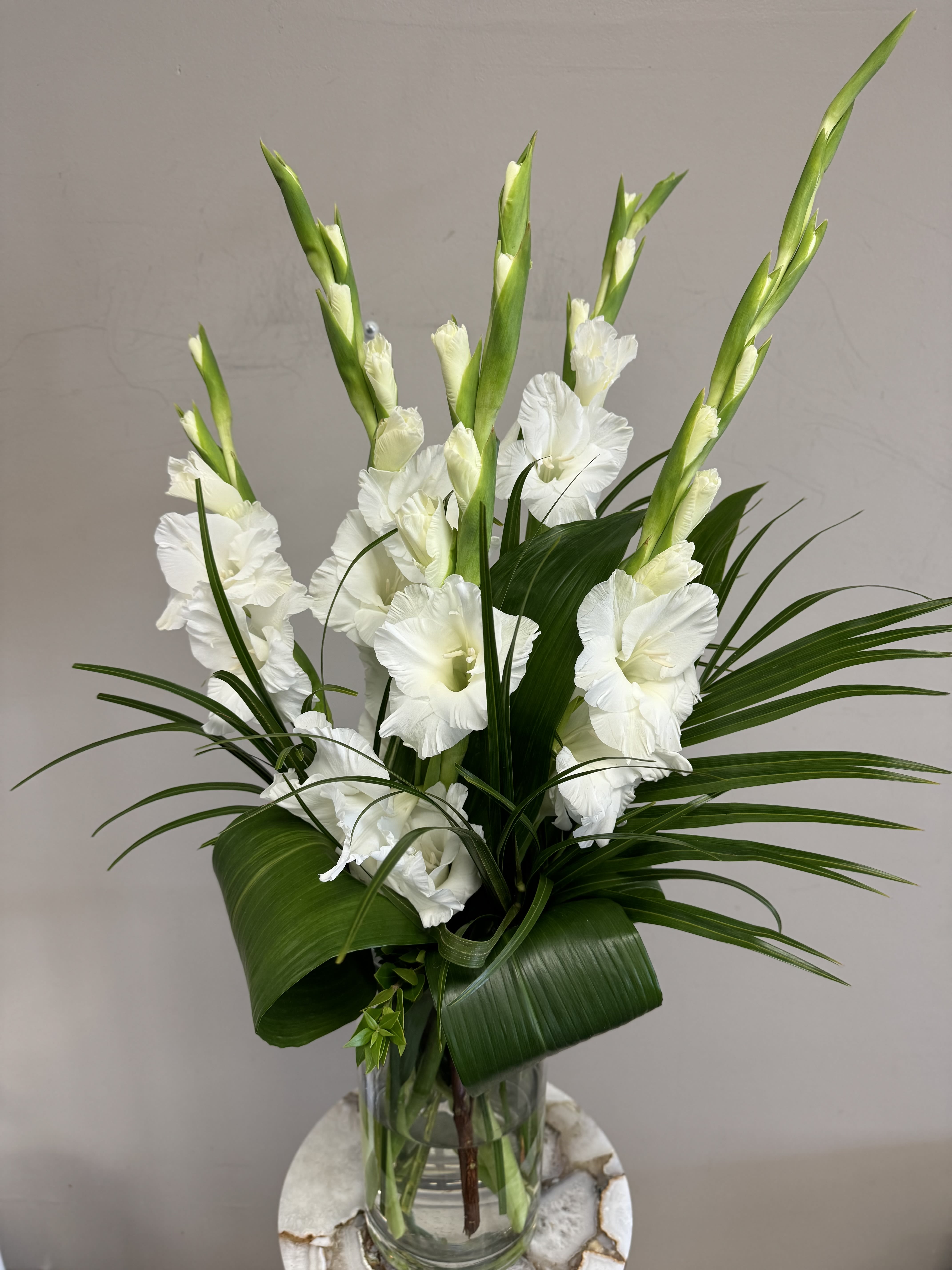 Gorgeous Gladiolus  - Elevate your space with our modern, simple, and elegant flower arrangement featuring striking gladiolas and lush greenery. Perfect for adding a touch of sophistication to any setting. Order yours today and bring natural beauty into your home!  Gladiolus' come in a variety of colors, call or put the color you would like in the florist notes to place an order for a different color.