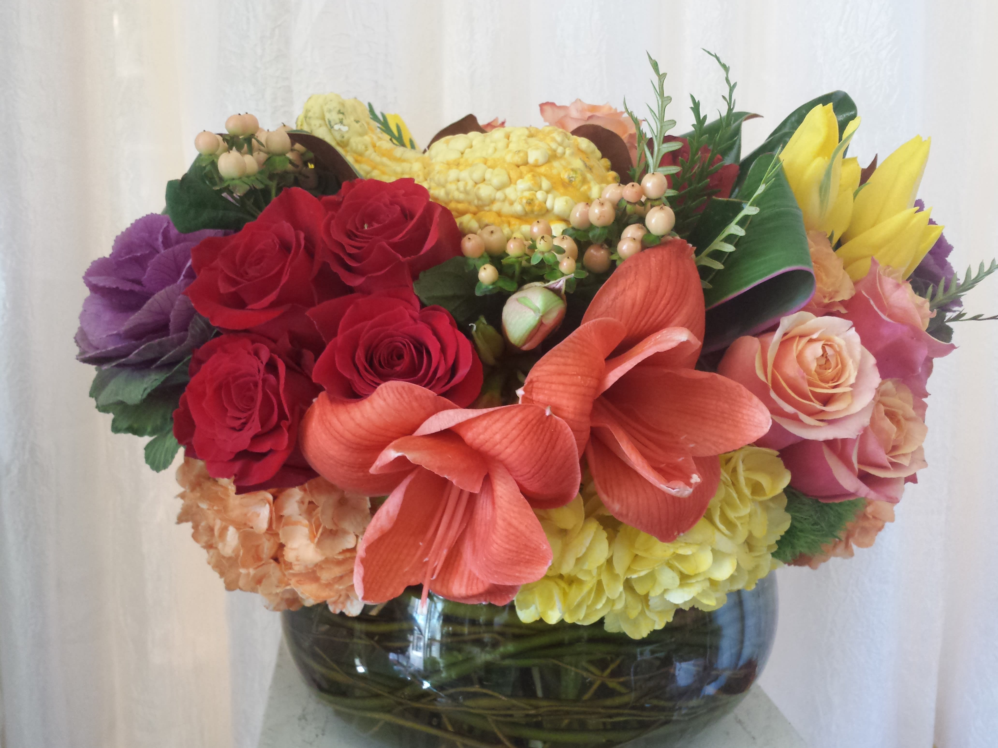low and round fall centerpiece - This extravagant centerpiece is composed of premium fall flowers such as amarylis, hydrangeas, roses, tulips and kale.