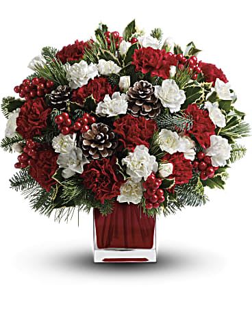 Christmas Stripes Centerpiece  - A nice arrangement of carnations, mini carnations, berries and pinecones done up in an elegant red cube vase. Filled in with a mix of Christmas greenery.