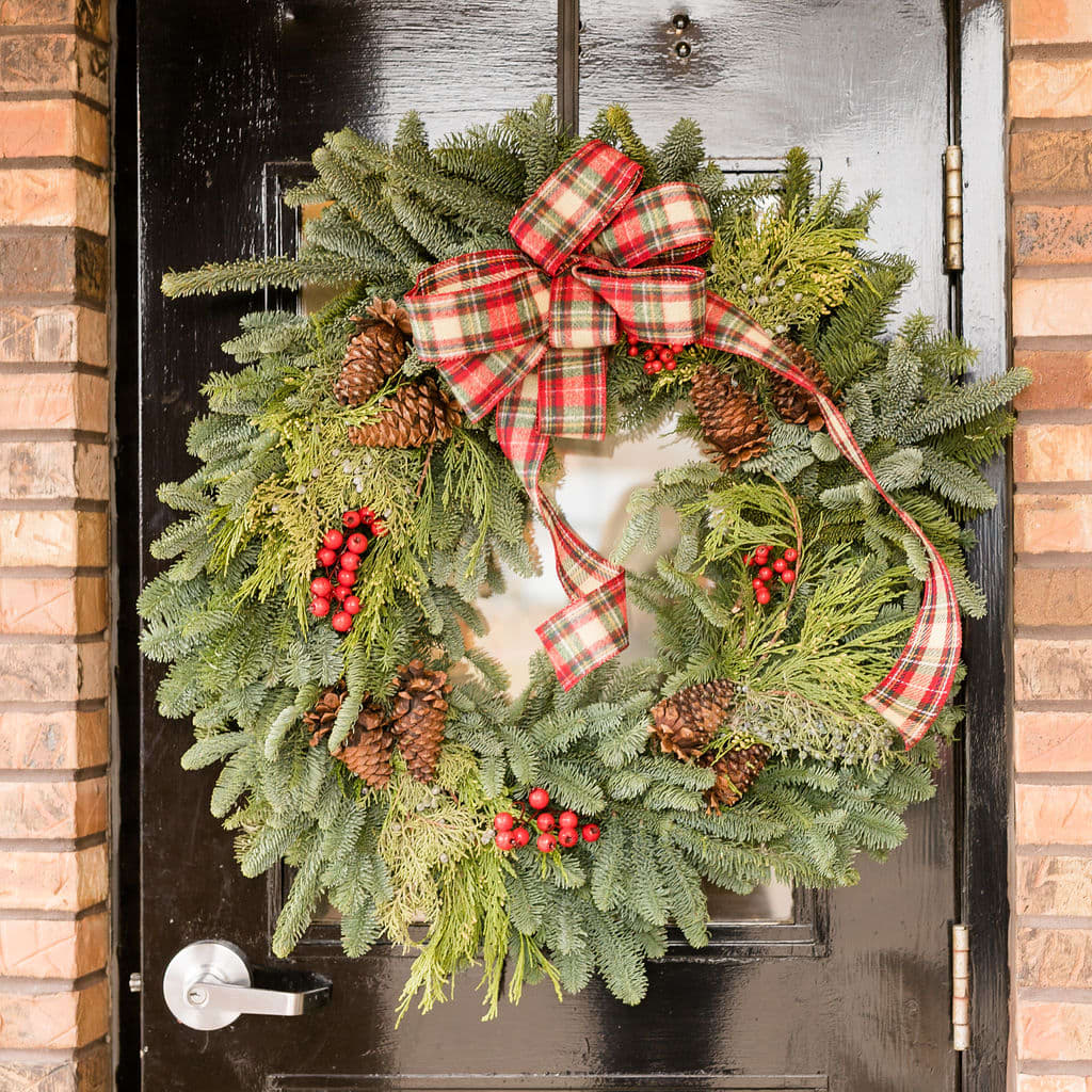 Welcome - Spread season's greetings beginning at the front door with a 24&quot; evergreen wreath.  A festive bow, red berries and pine cones add the finishing touches to a mix of lush evergreen boughs.  Approximately 24&quot; Tall X 24&quot; Wide 