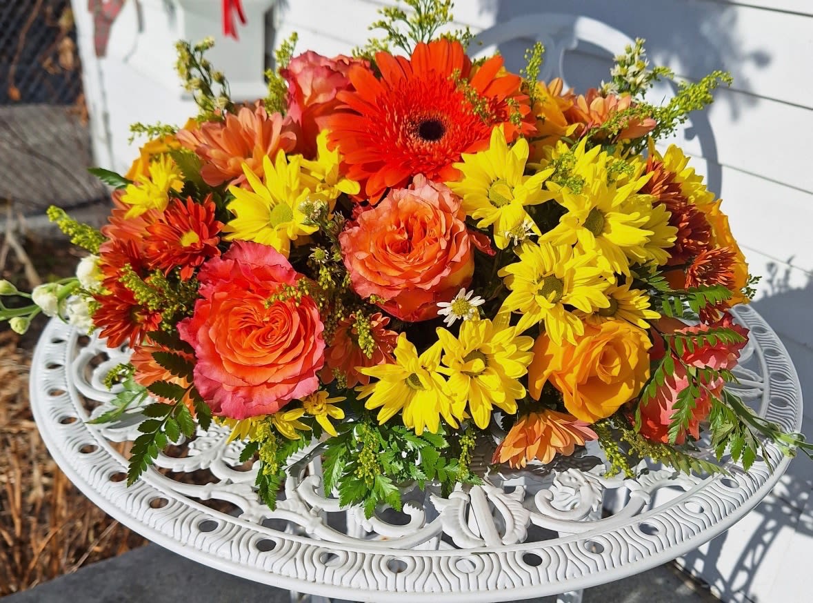 Thanksgiving Centerpiece -  This bountiful arrangement has orange roses, gerberas, carnations, bronze and yellow daisies, solidago and monte