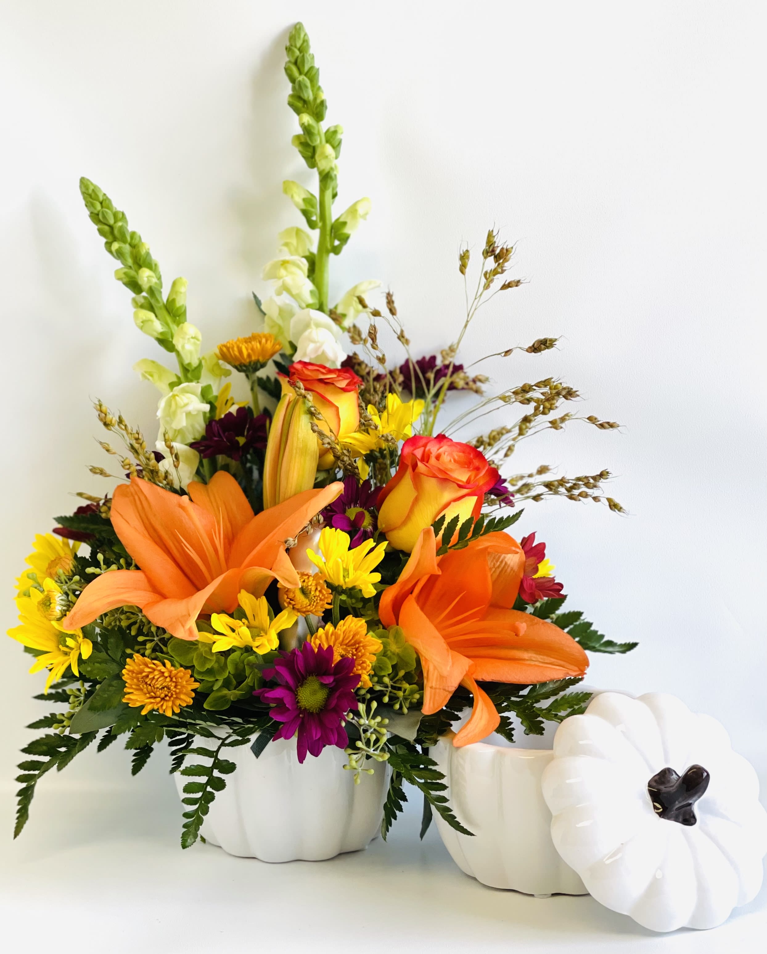 Sunrise Harvest Bouquet by Barb’s Flowers - White ceramic pumpkin bouquet filled with orange asiatic lilies, daisies, mums, roses, snapdragons and fall accent flowers.