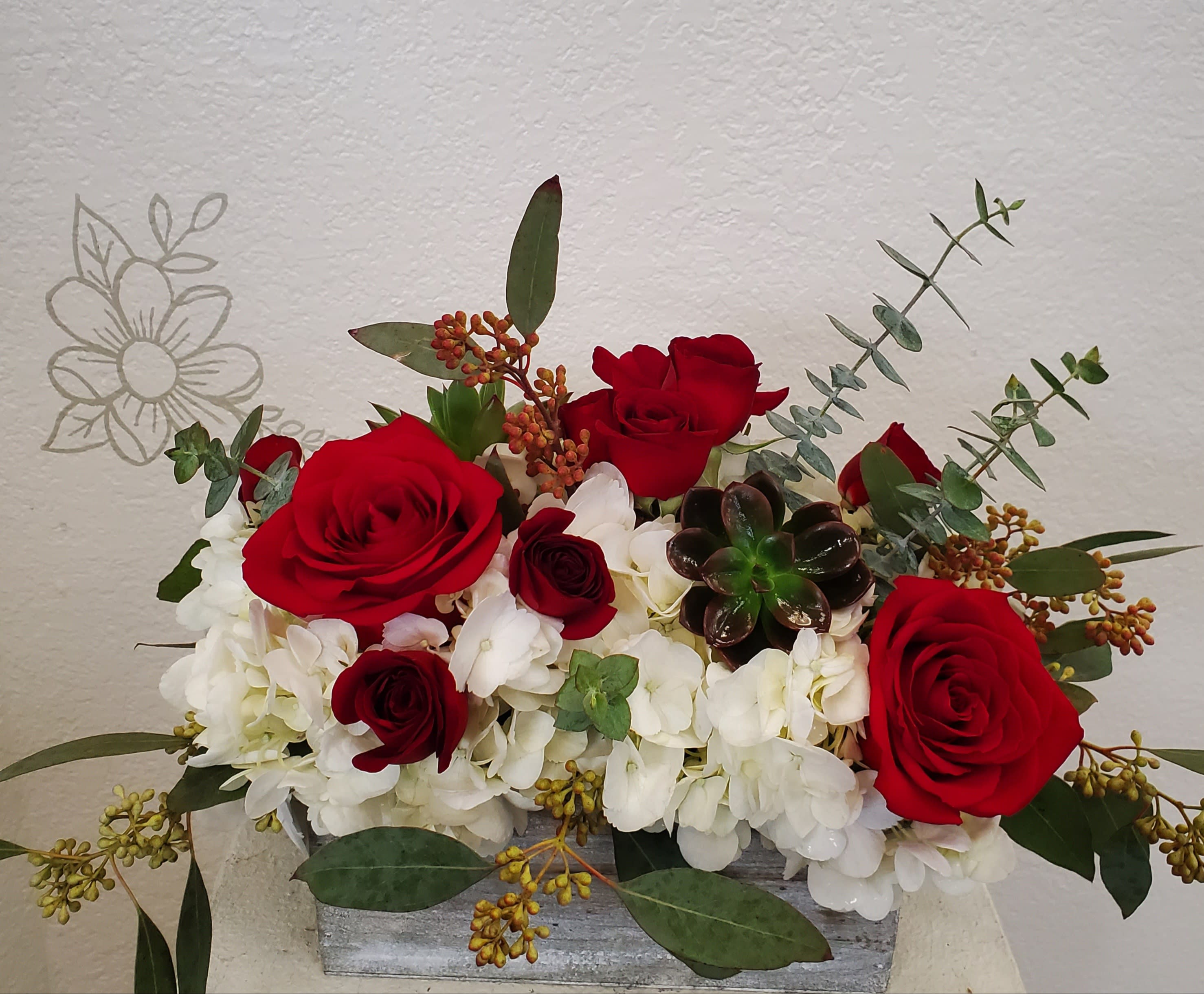 The Red Succulent  - A Garden styled arrangement to include Red roses, white hydrangea and baby succulents in a wood box. 